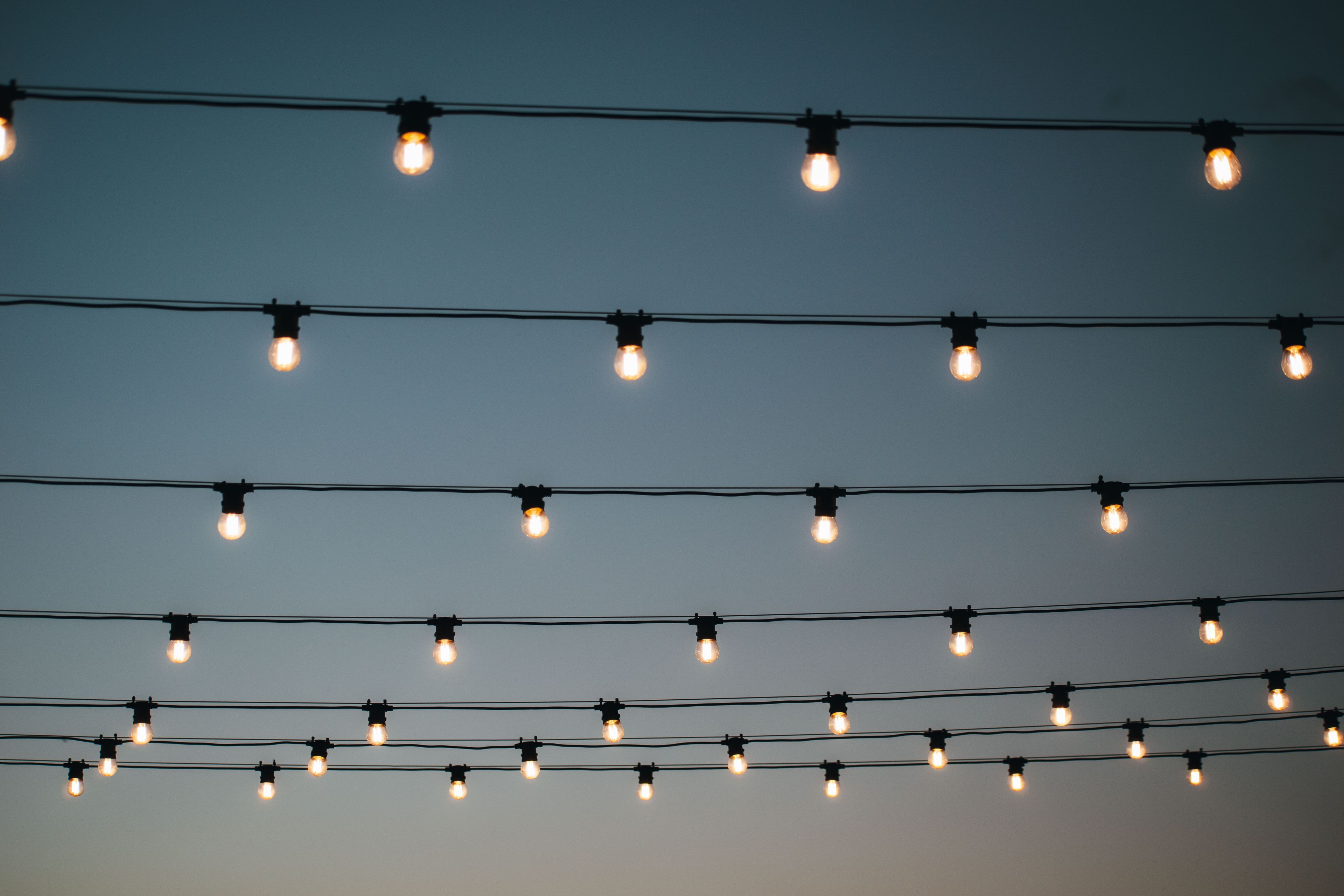 An image of festoon lighting and a twilight sky