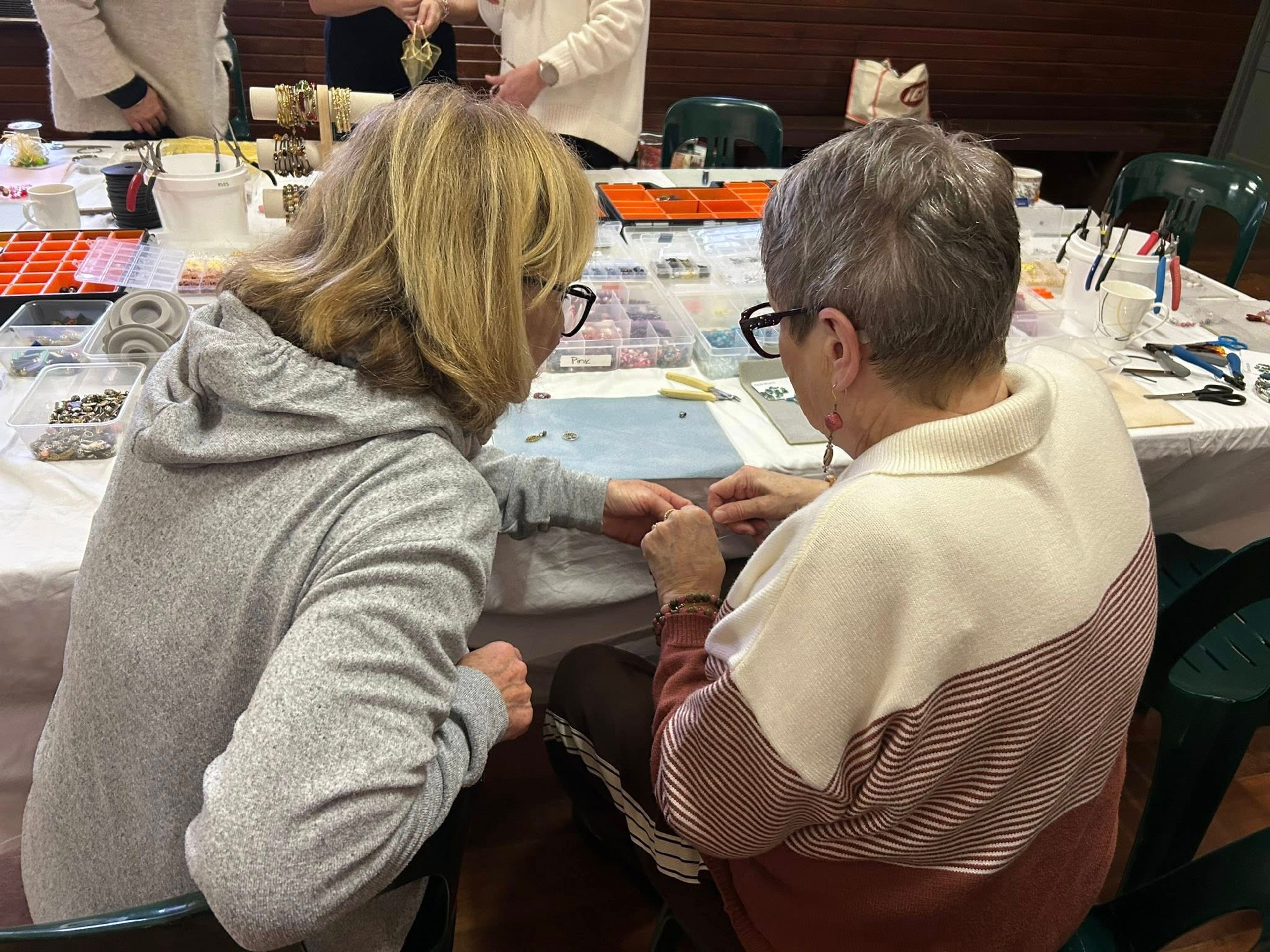 Image of two people doing craft work from the back