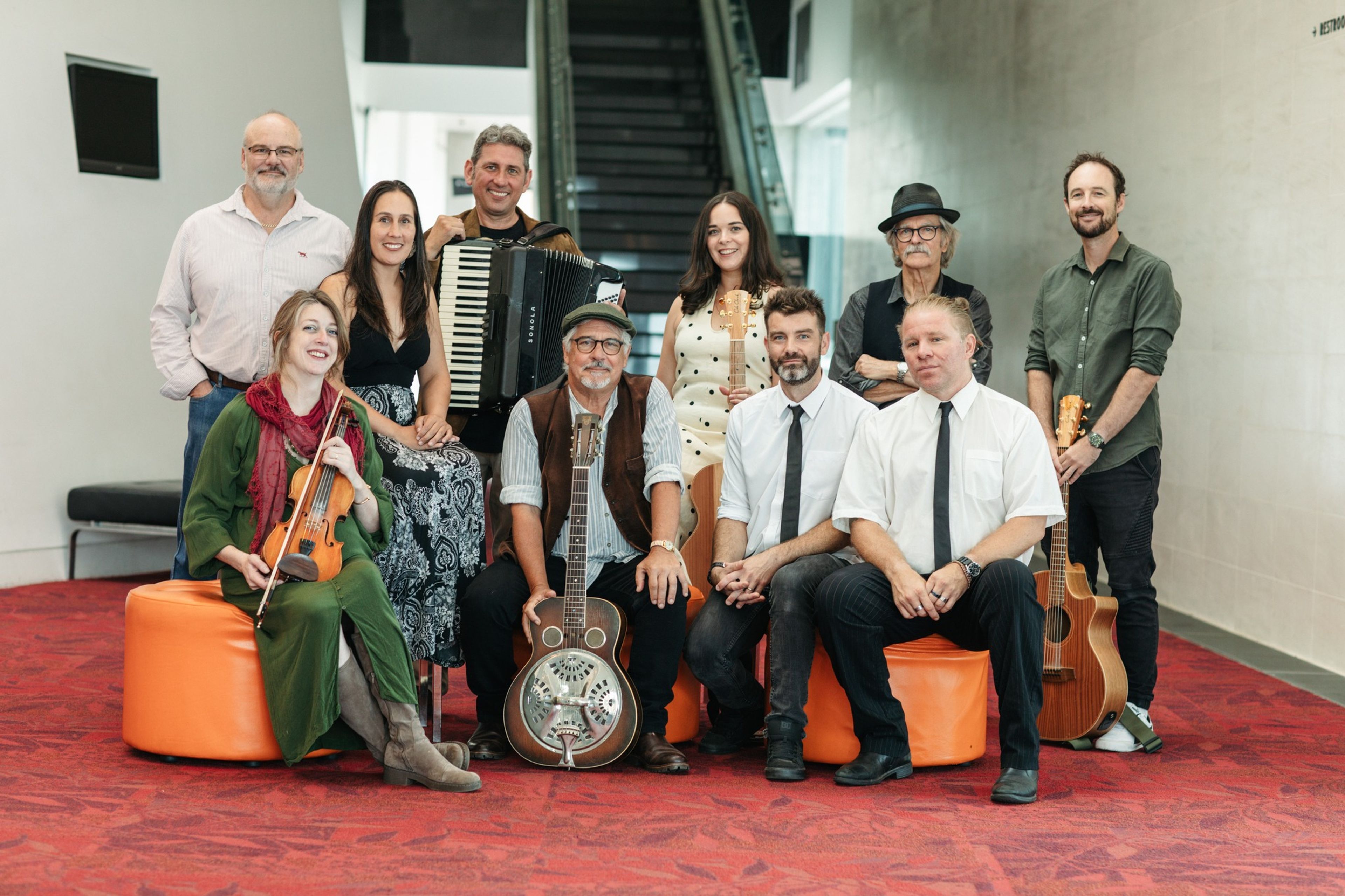 A group of musicians gather with their instruments in the foyer of the Albany Entertainment Centre. 