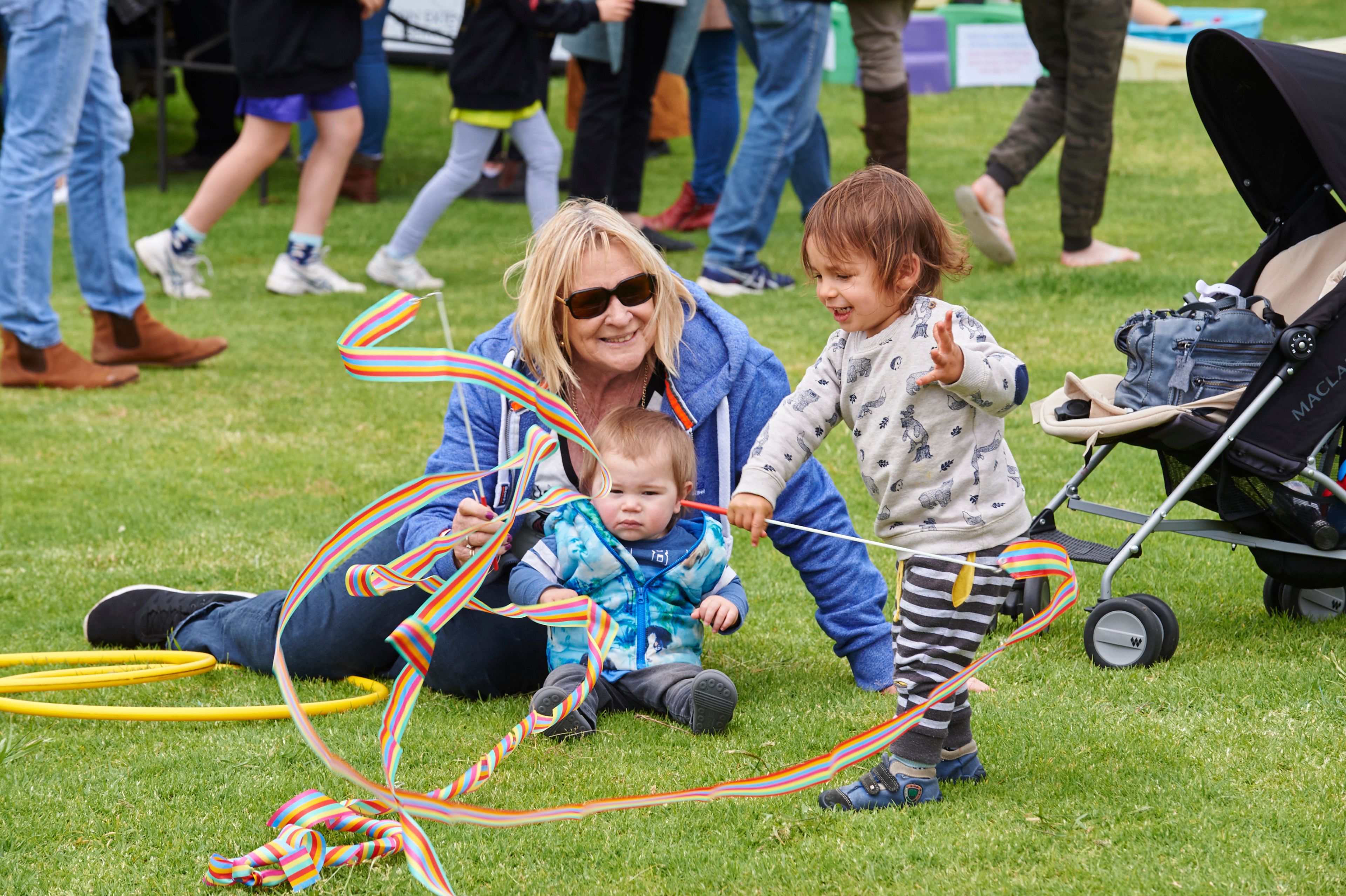 Children wave ribbon flags