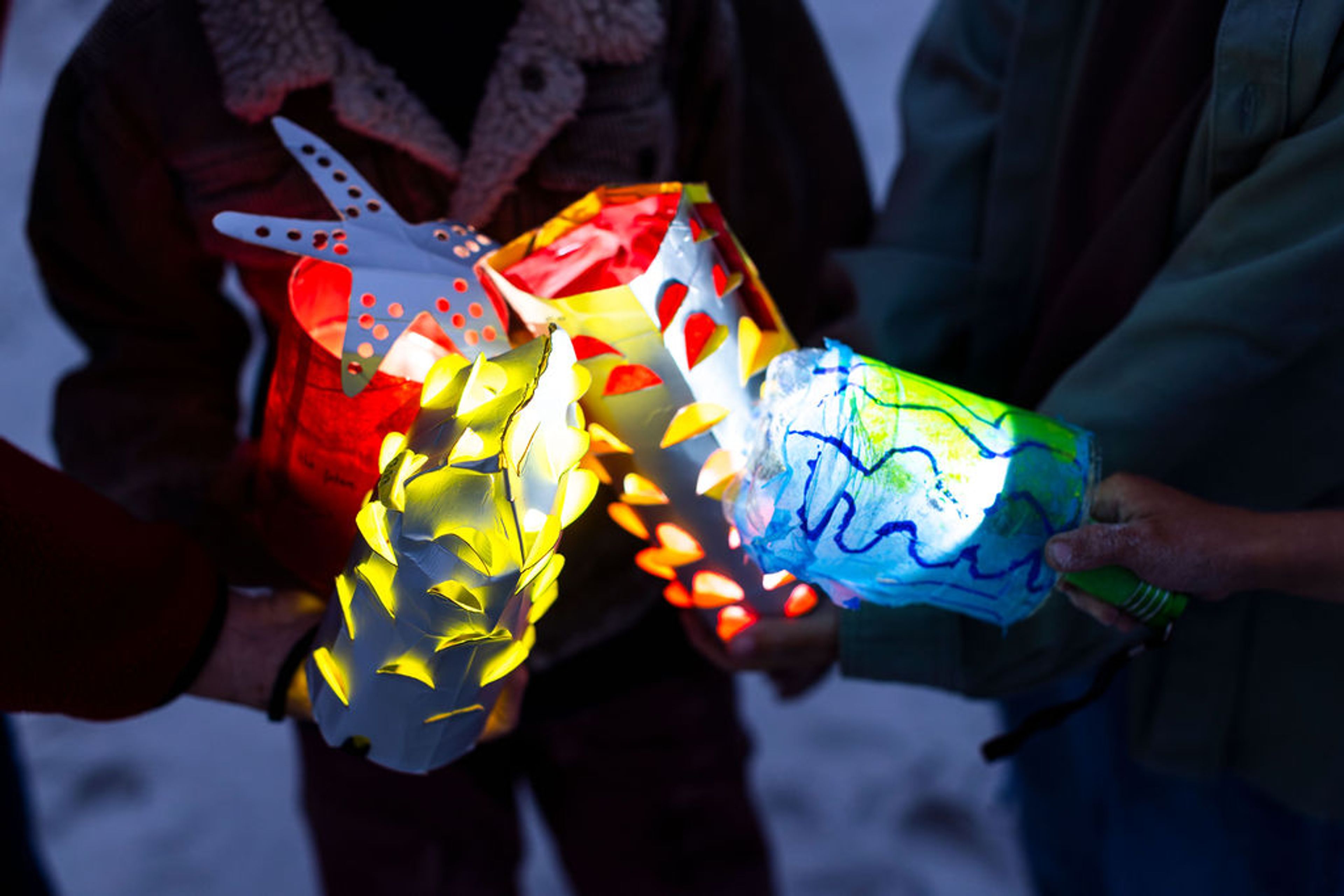 A group of colourful lanterns illuminating the dark