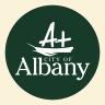 The City of Albany logo sitting over a green circle background.