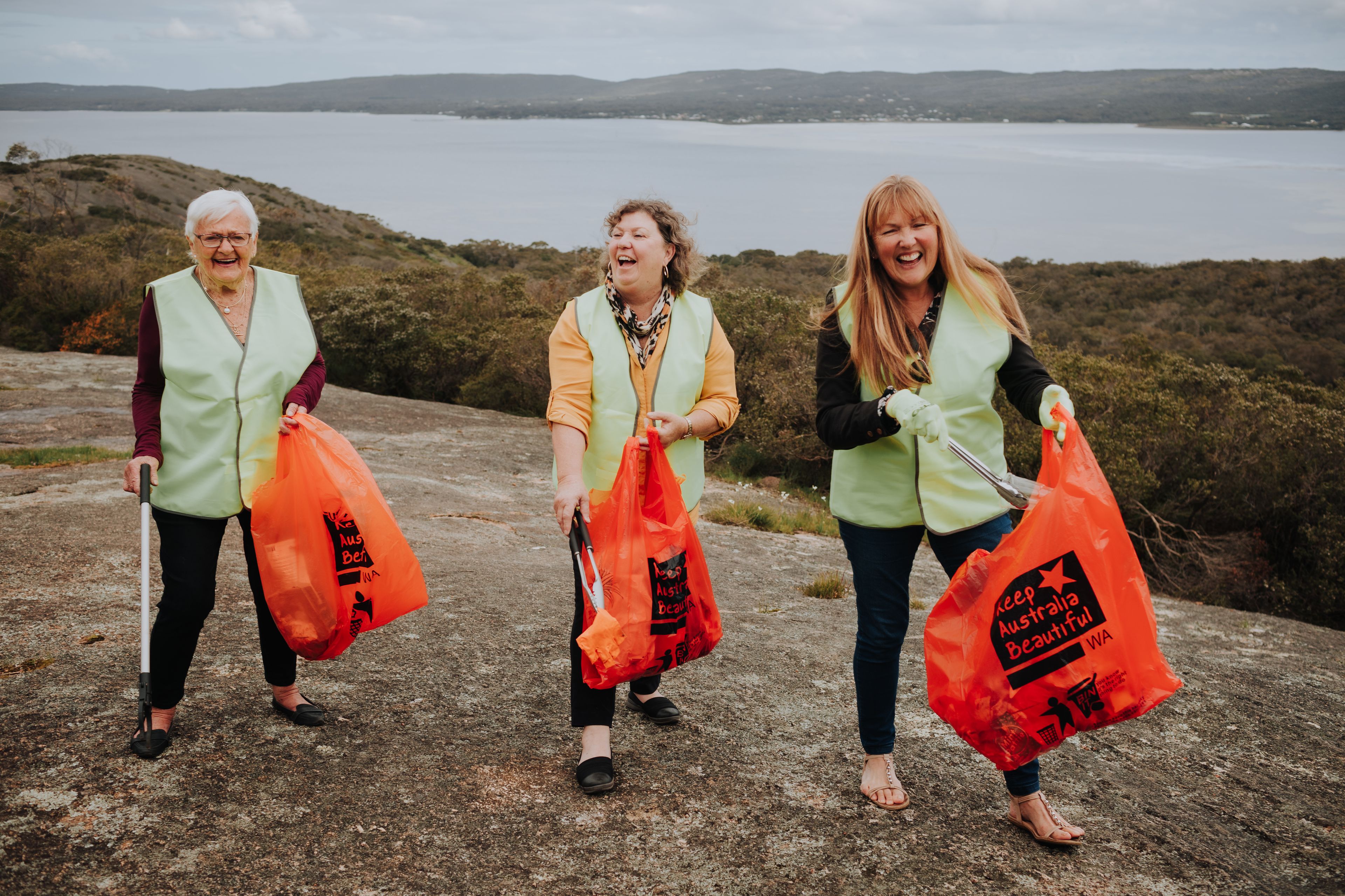 Three volunteers collecting rubbish
