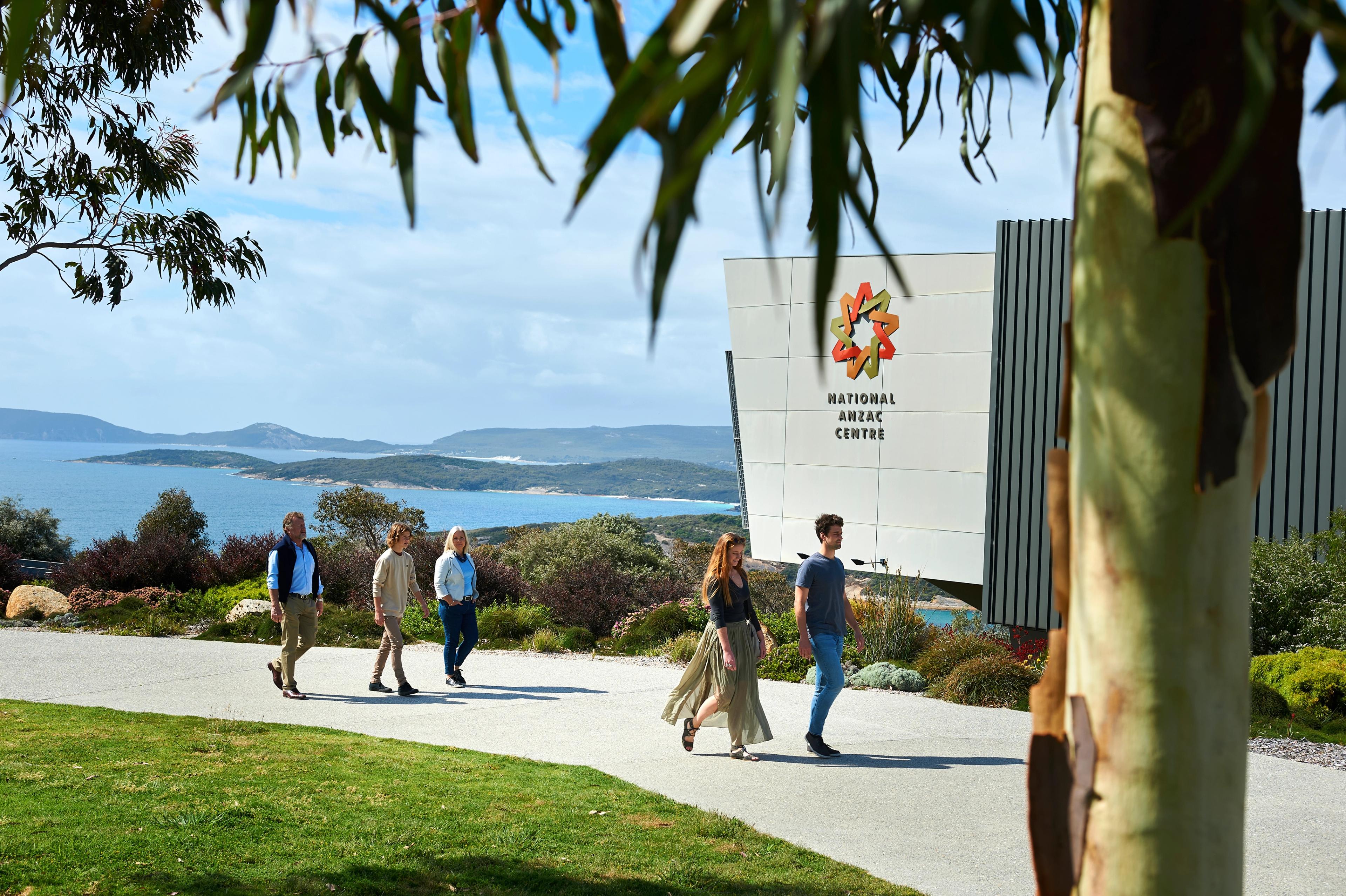 Five people walking in front of the National Anzac Centre in Albany, Western Australia