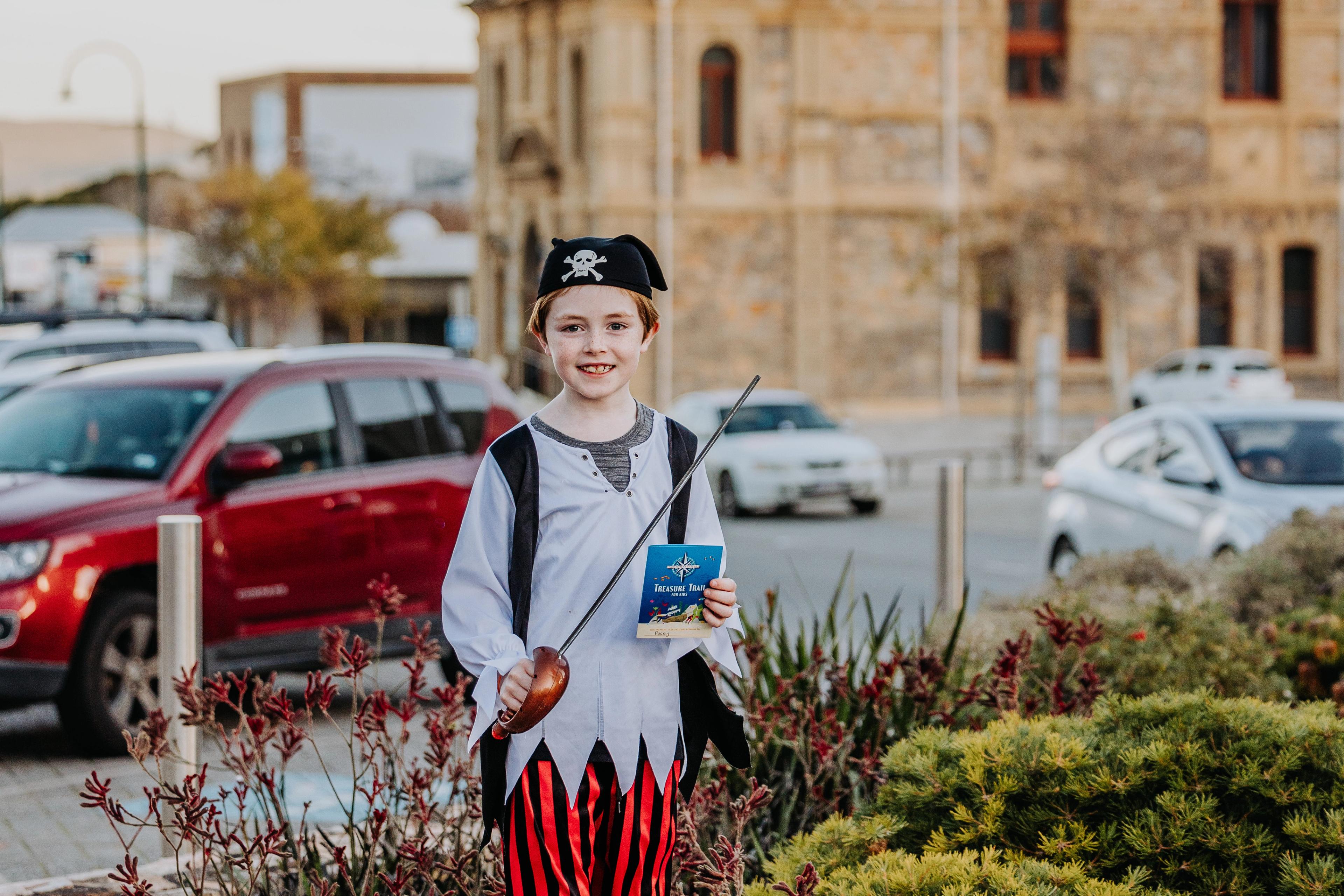 A young boy dressed as a pirate stands on York Street