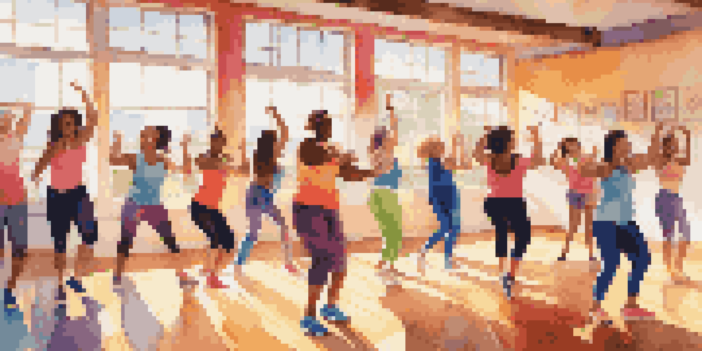 A lively Zumba class with diverse participants dancing energetically in a bright studio.