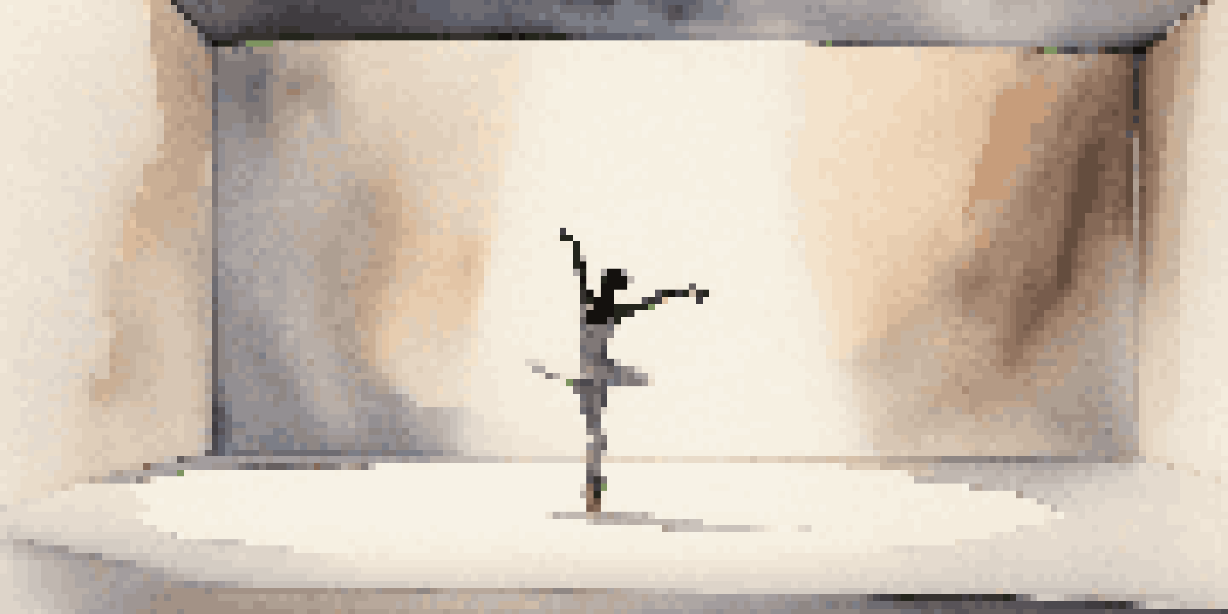 A minimalist dance set with a single dancer illuminated by soft light on an empty stage.