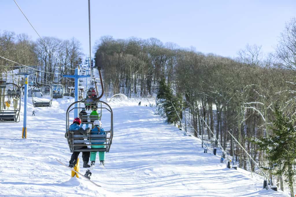 A pair of skiers riding the chairlift up to their slope at Cataloochee Ski Area.