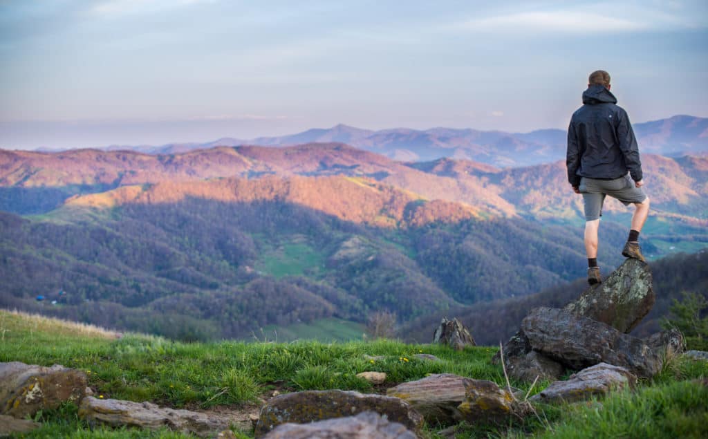 Hiker admiring a view of the Great Smoky Mountains.