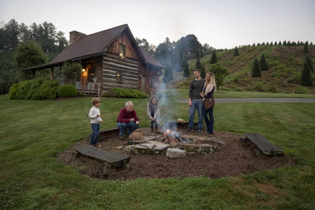 Family gathered around the fire at a Boyd Mountain cabin