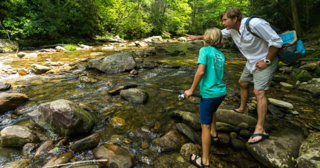Father and son fishing at Sunburst Swimming Hole in the NC Smoky Mountains.