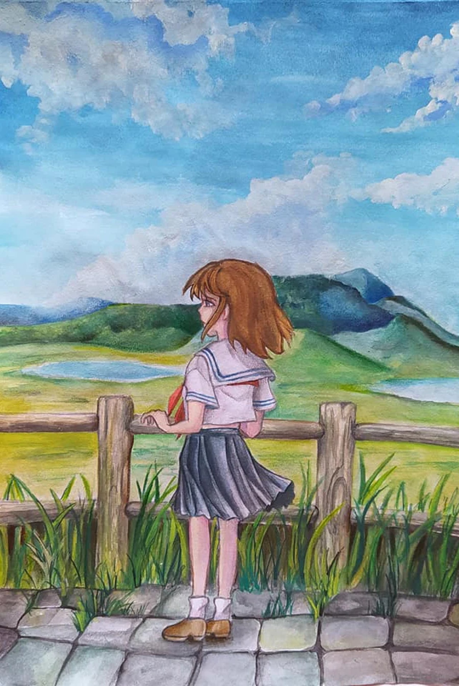 A girl looking across bright fields toward distant blue mountains