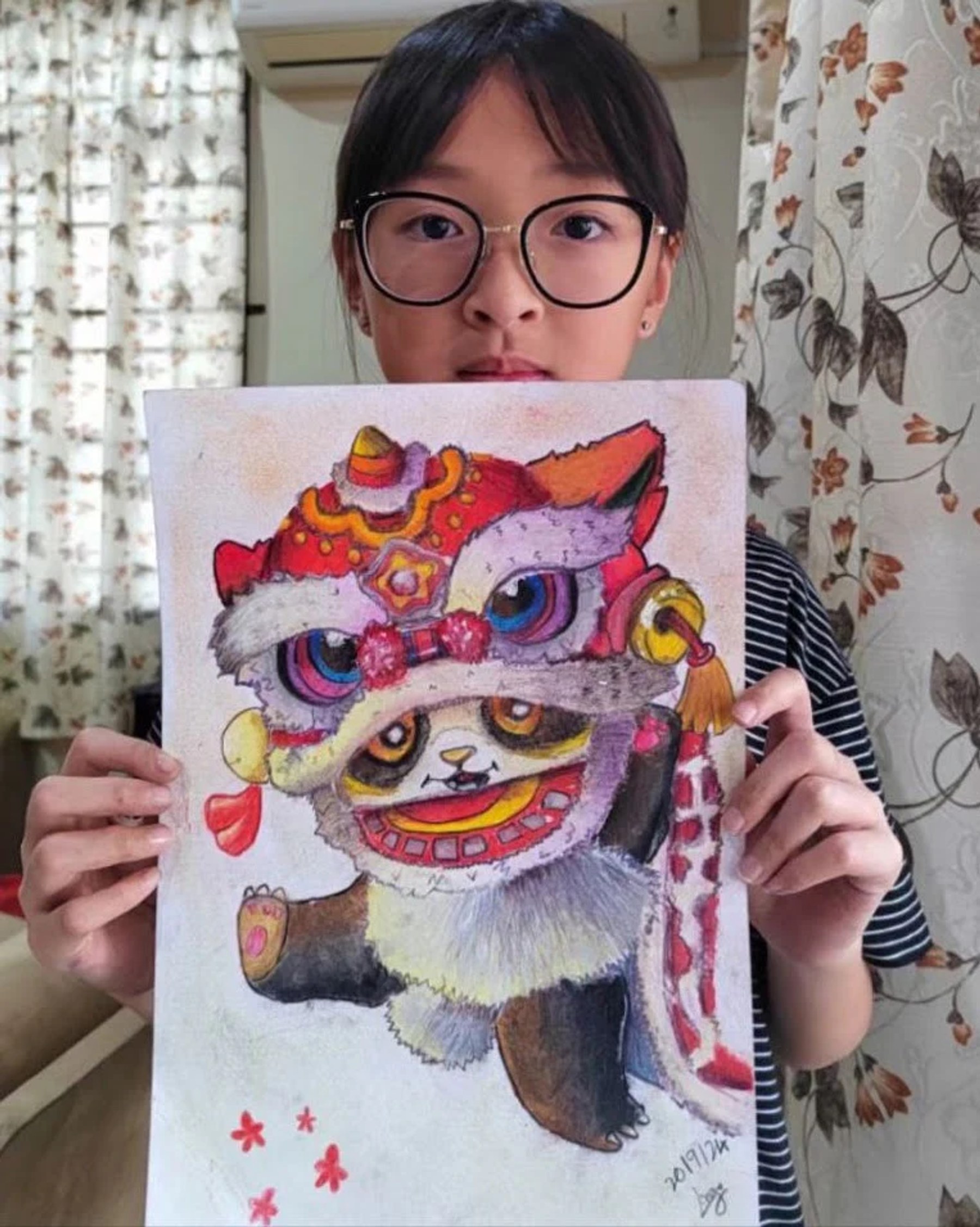 Student holding a vivid pink lion dance drawing