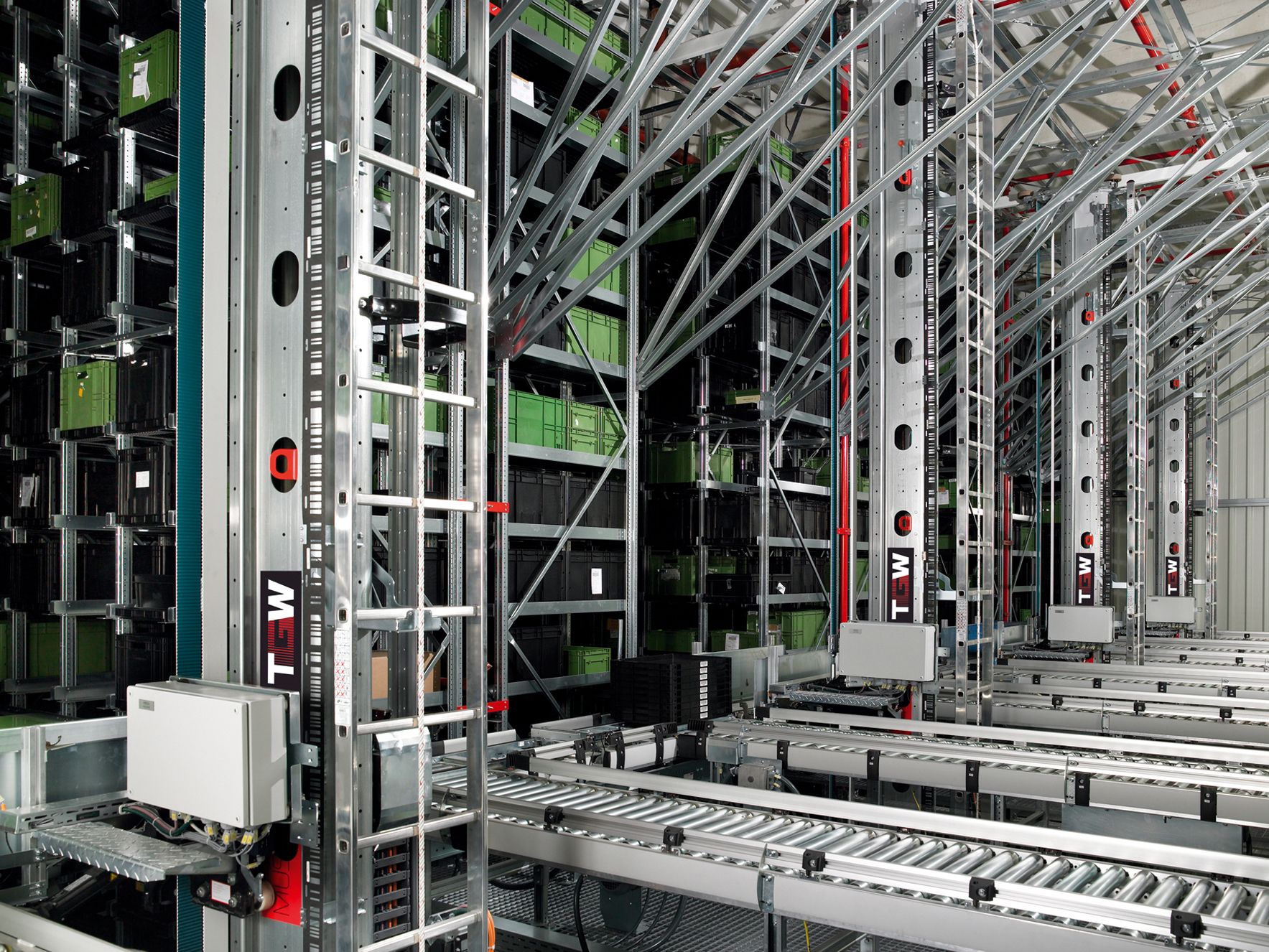 Automated warehouse aisle with high racking and moving inventory systems.