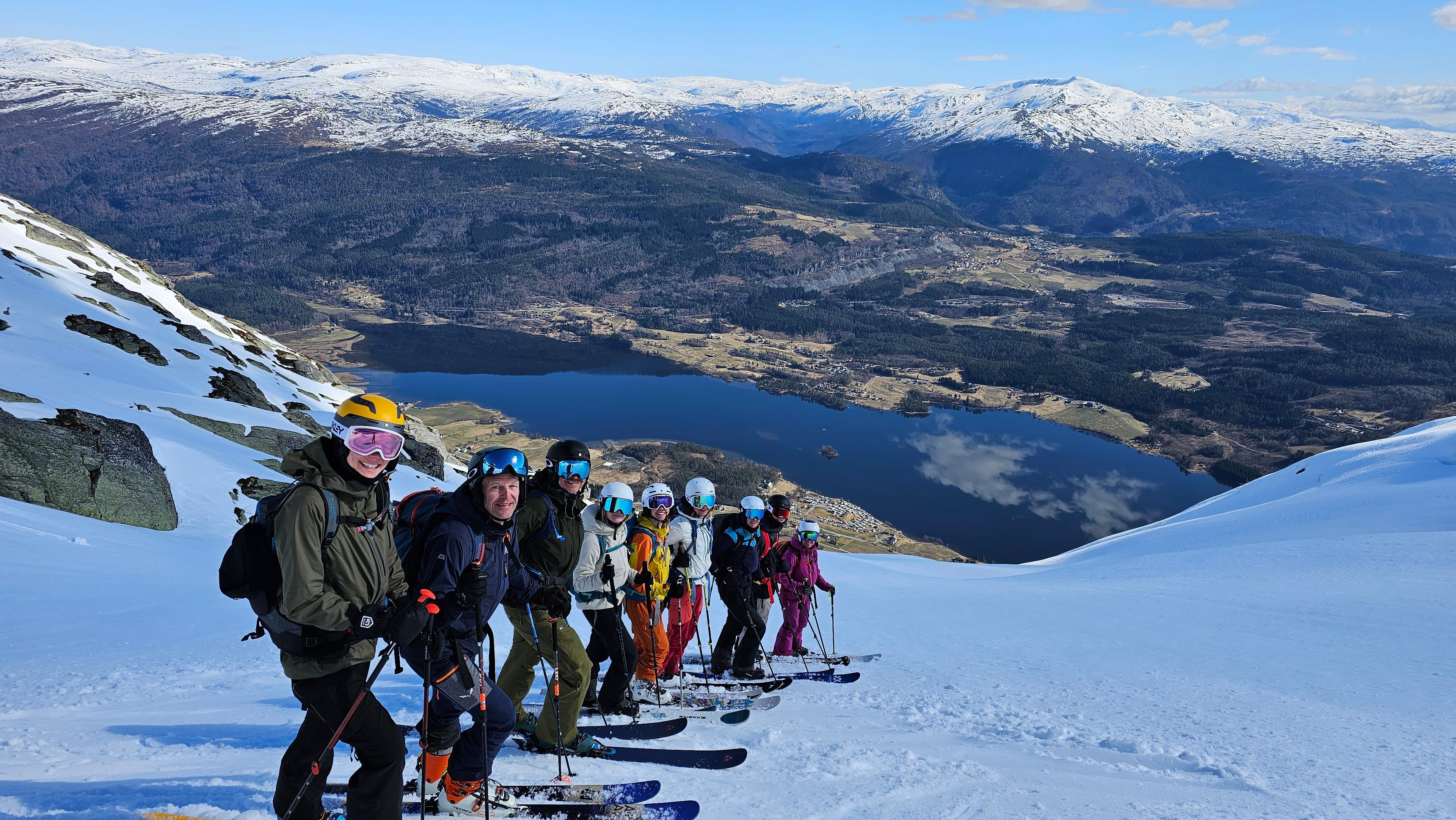 Skiiers posing with beautiful view in the background