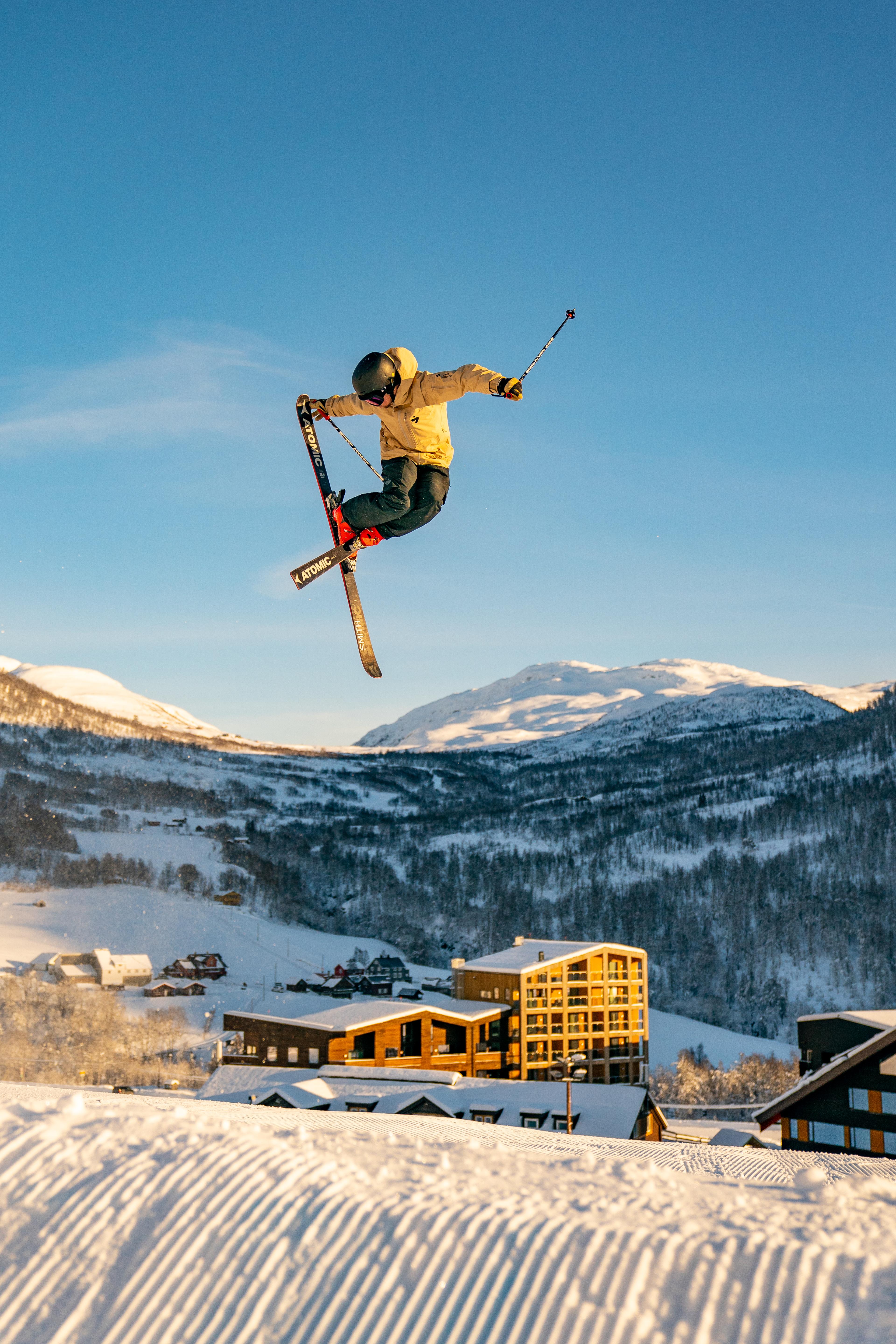 Person makes a big jump on slalom with Myrkdalen in the background