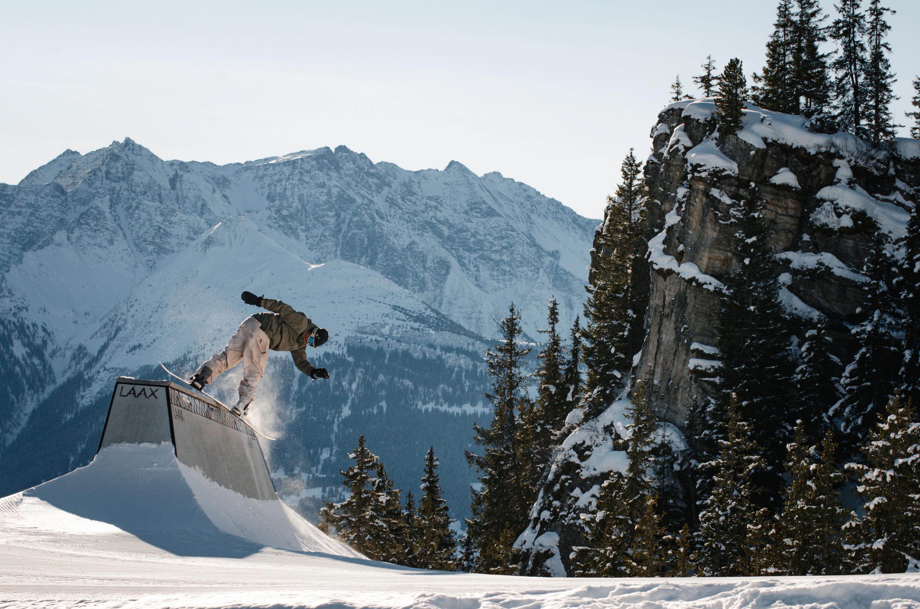 Snowboarder performing a trick in the snowpark at LAAX, Switzerland