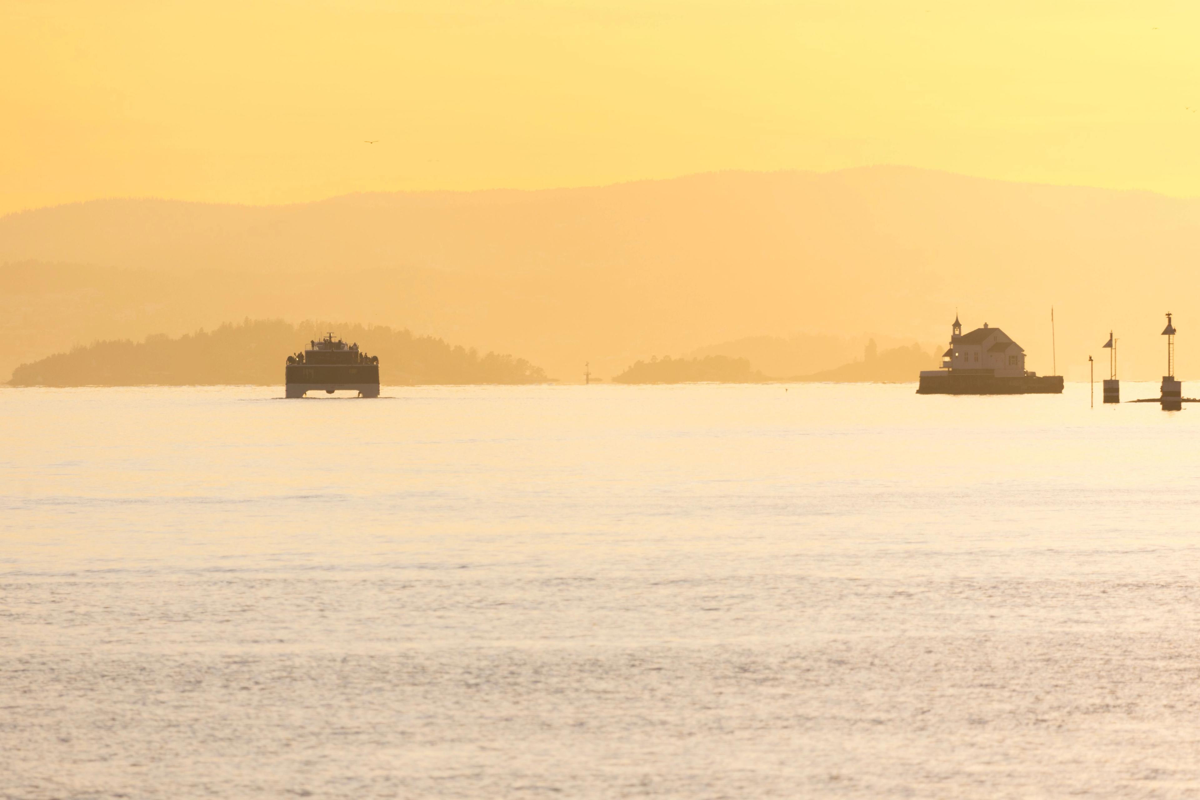 Fjord cruise sailing away into the sunset