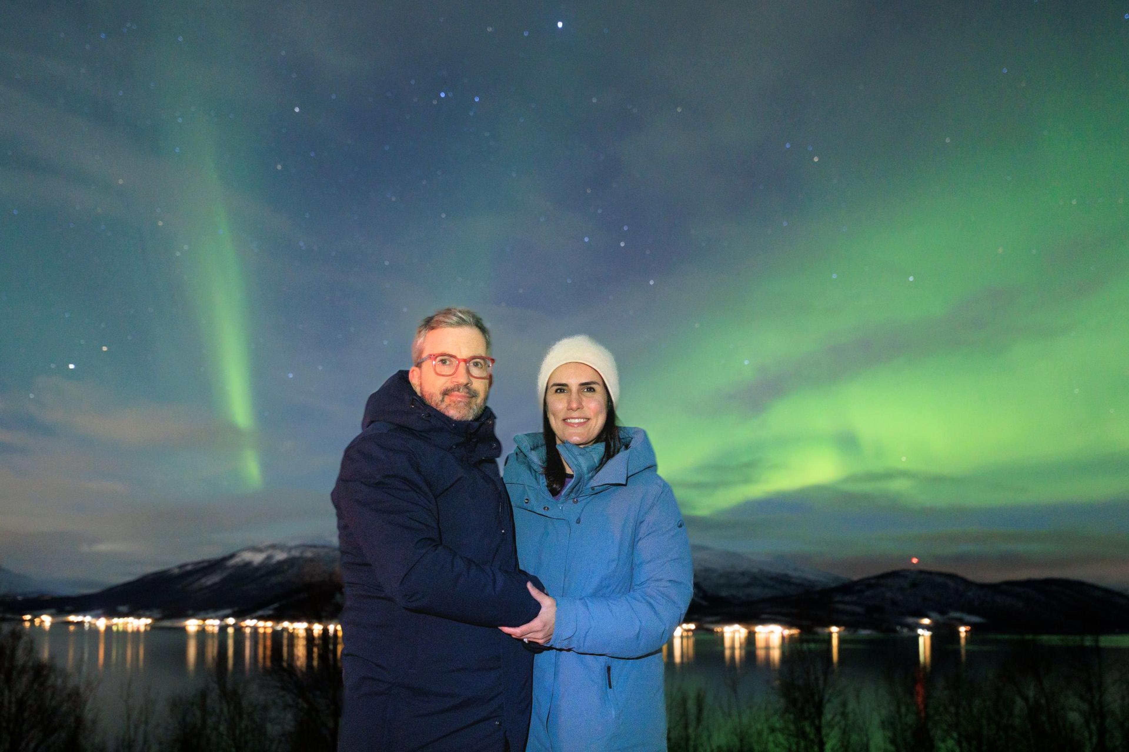 A couple photographed beneath the Northern Lights during a tour in Narvik.