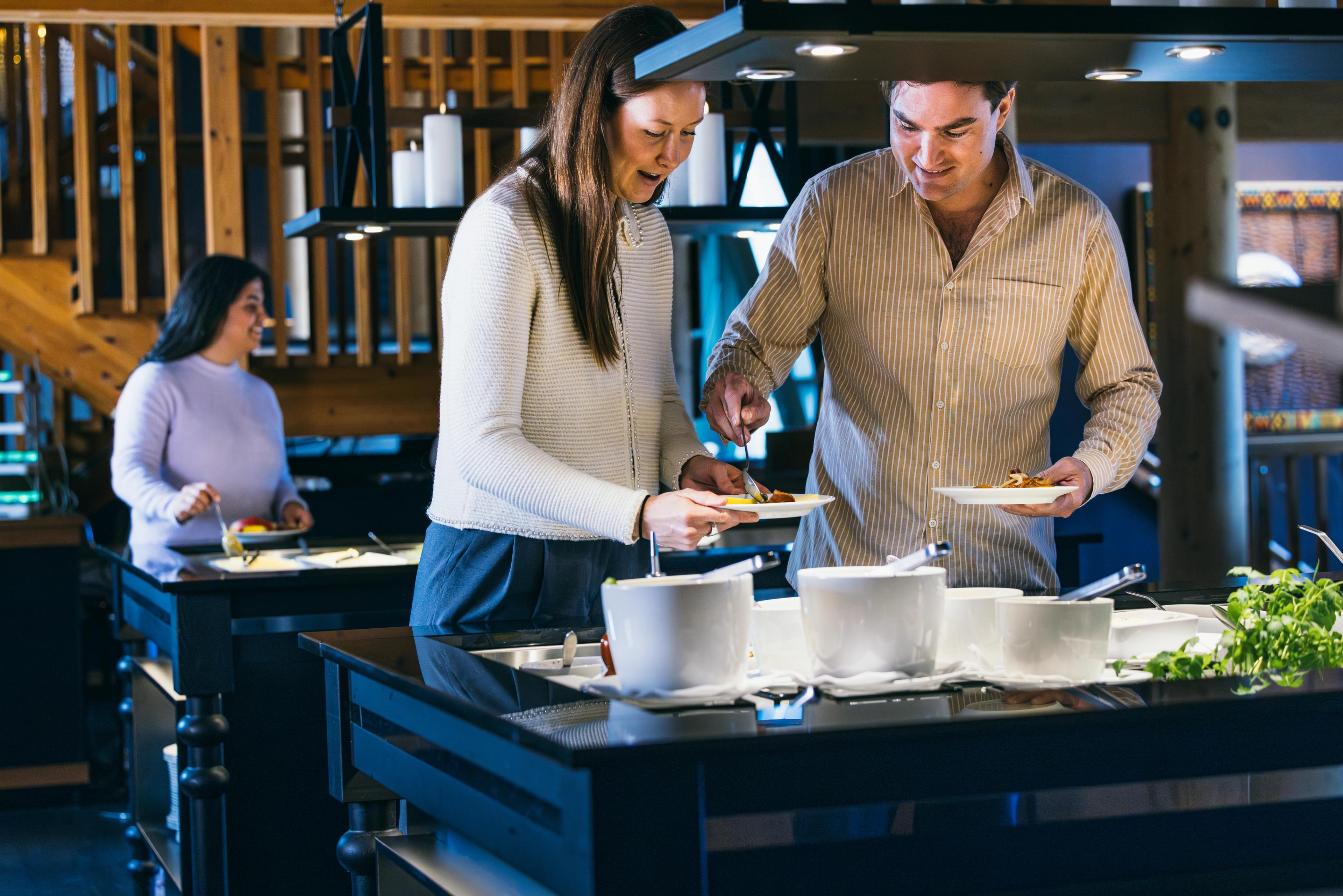 A couple at a buffet.