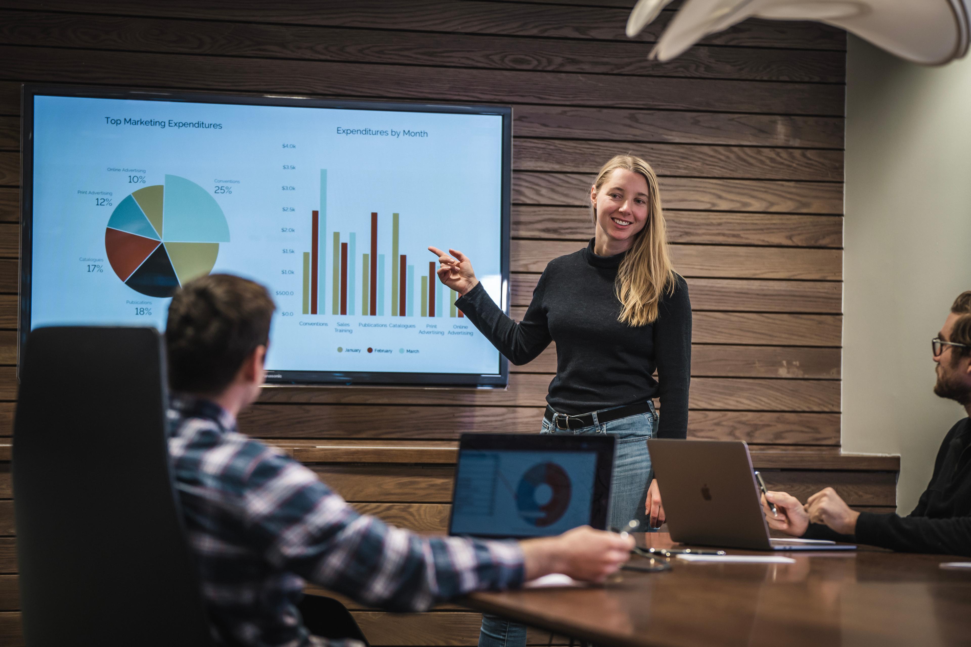 A woman gives a presentation in front of a group of people