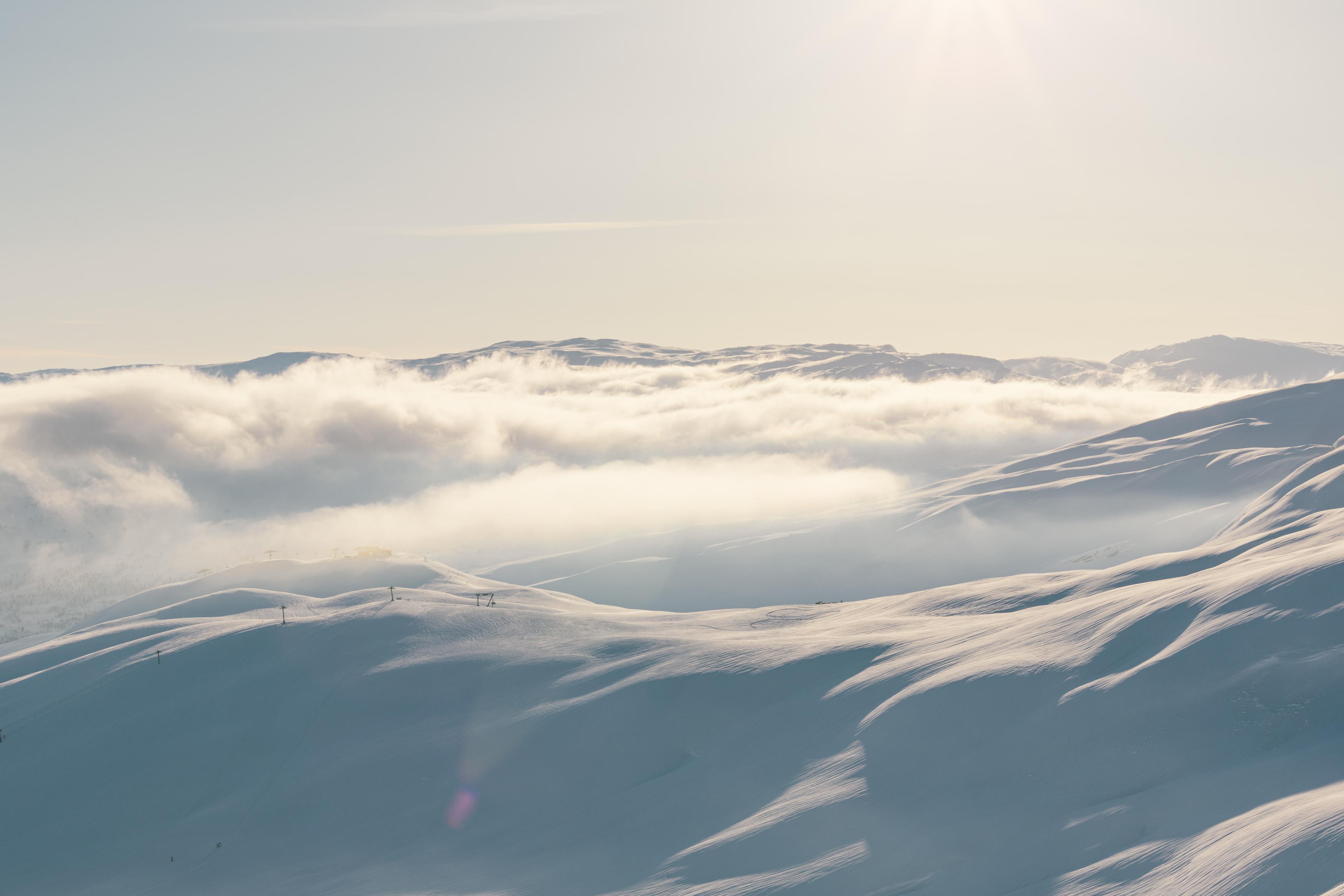 The clouds lie low over the mountain peaks covered with snow.