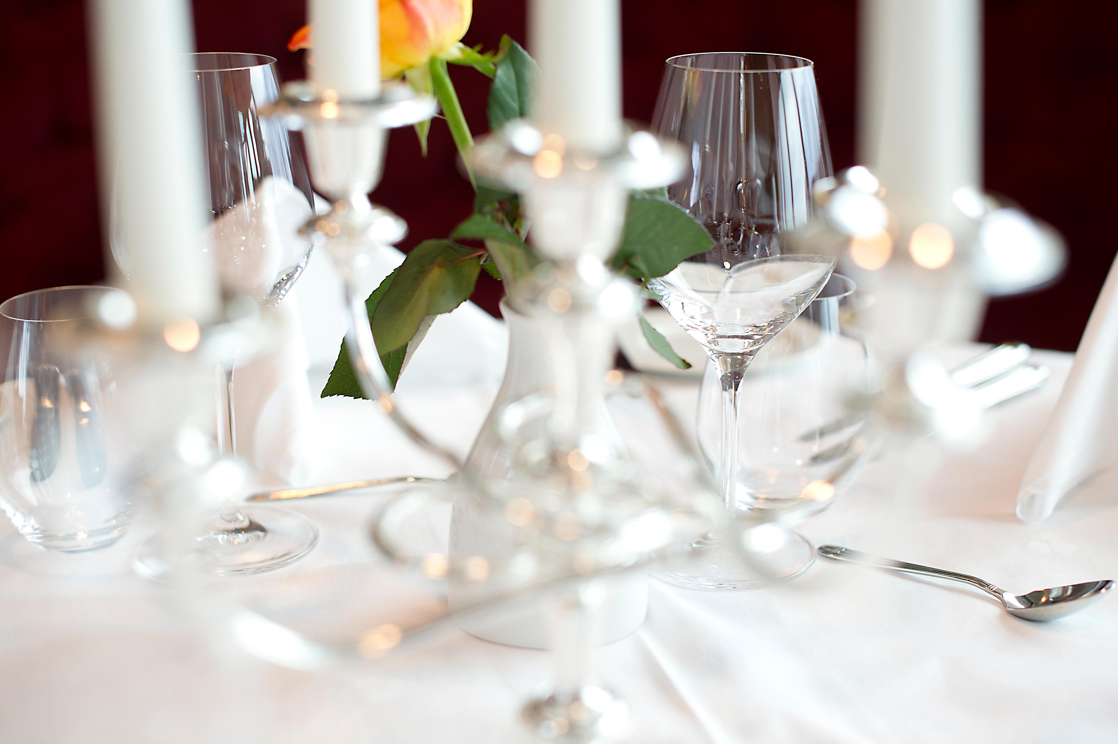 Nicely set table with candles, flowers and wine glasses