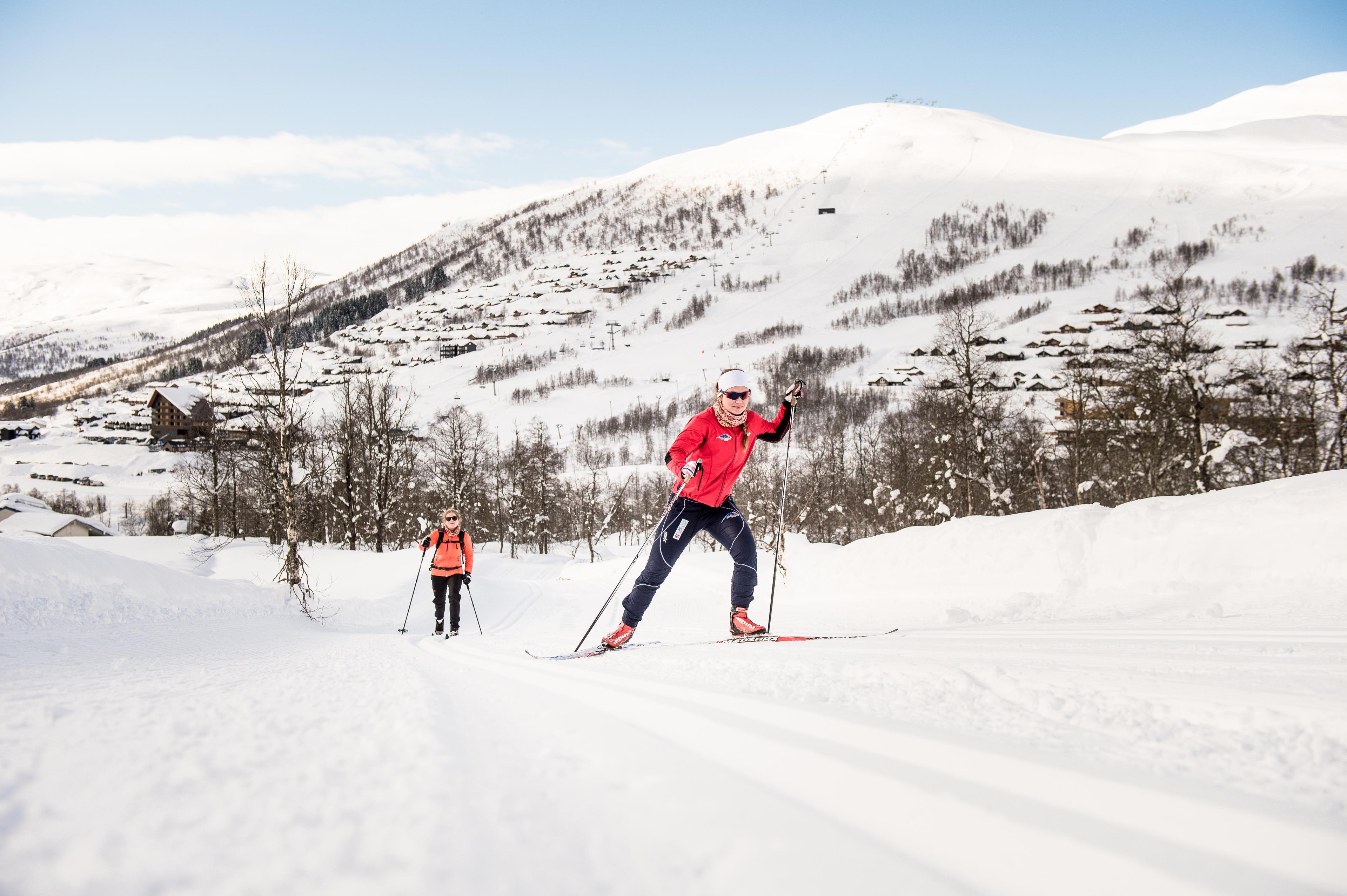 A cross-country couple skates up the slopes.