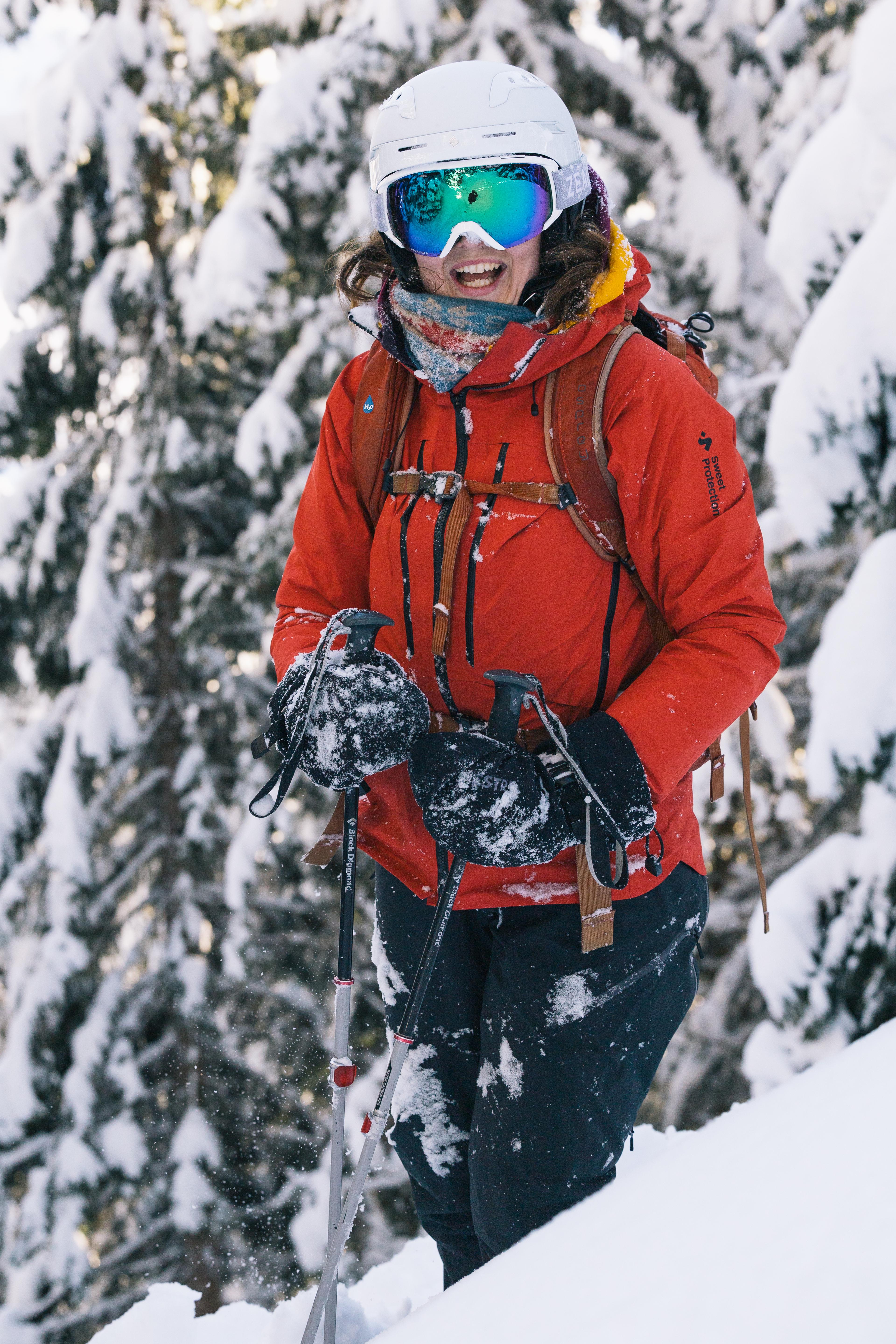 Skier stand in deep snow on a forest trail.