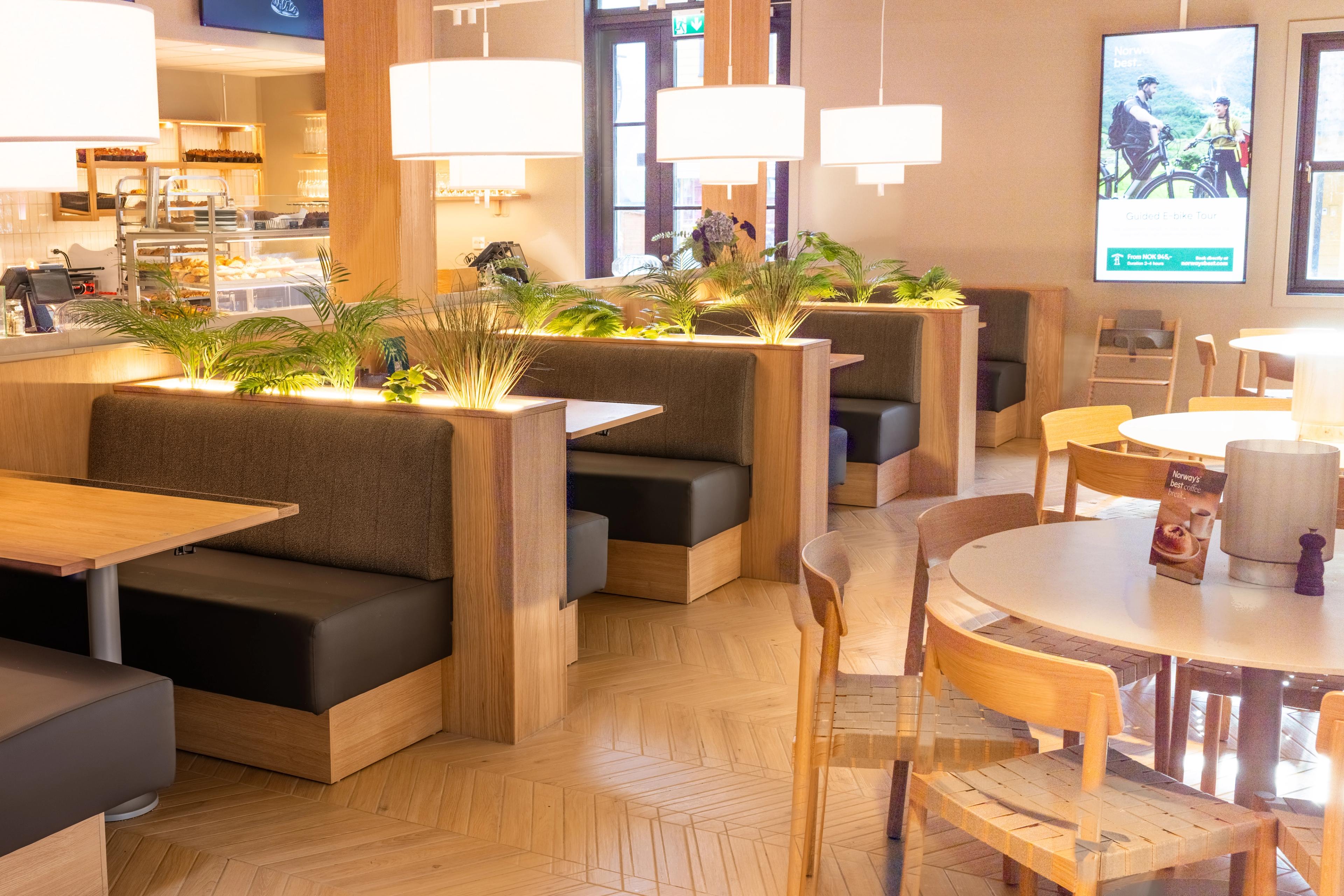 Interior photo of Flåm Bakery. Benches, tables and chairs in Scandinavian style.