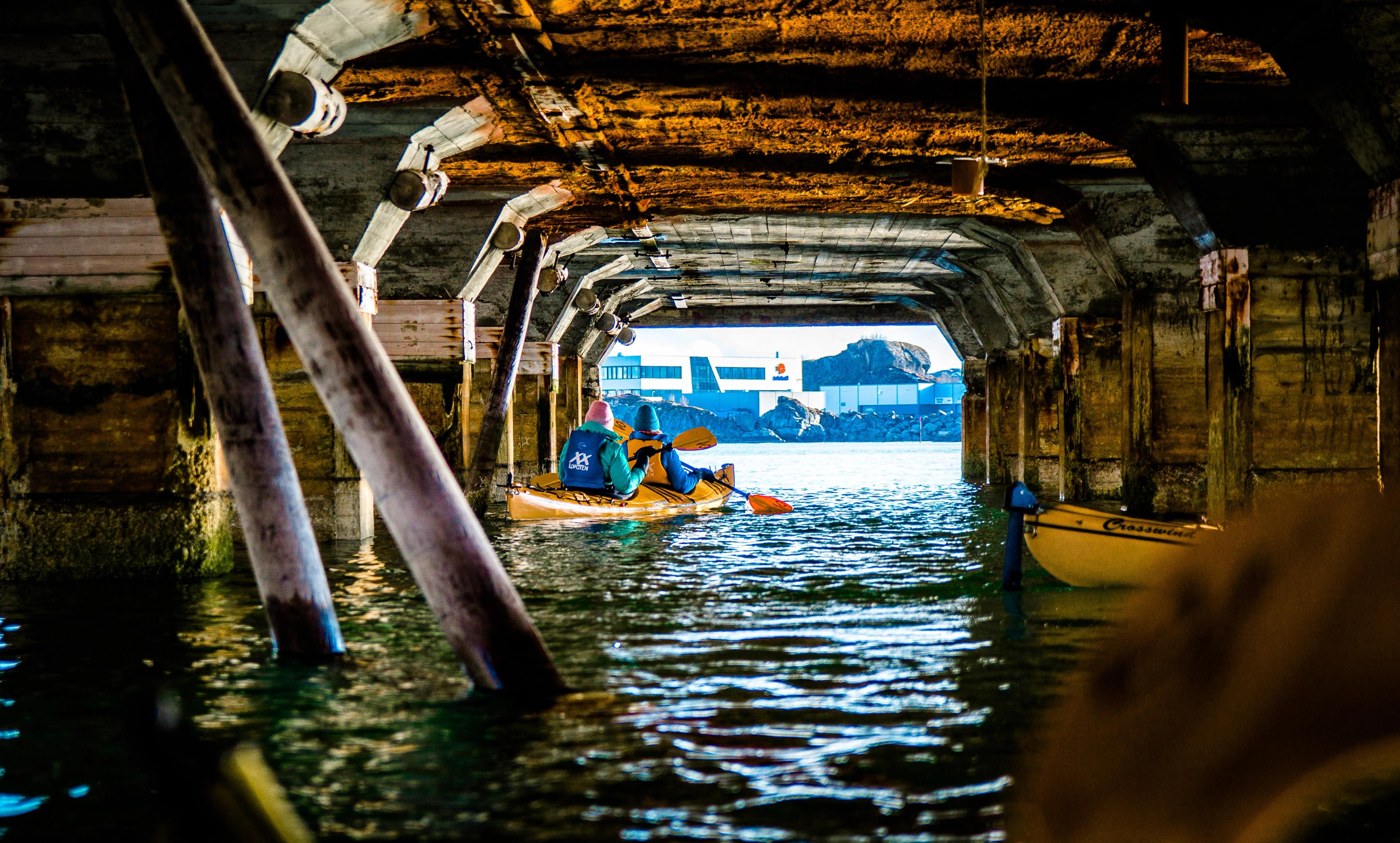 Paddling under a pier