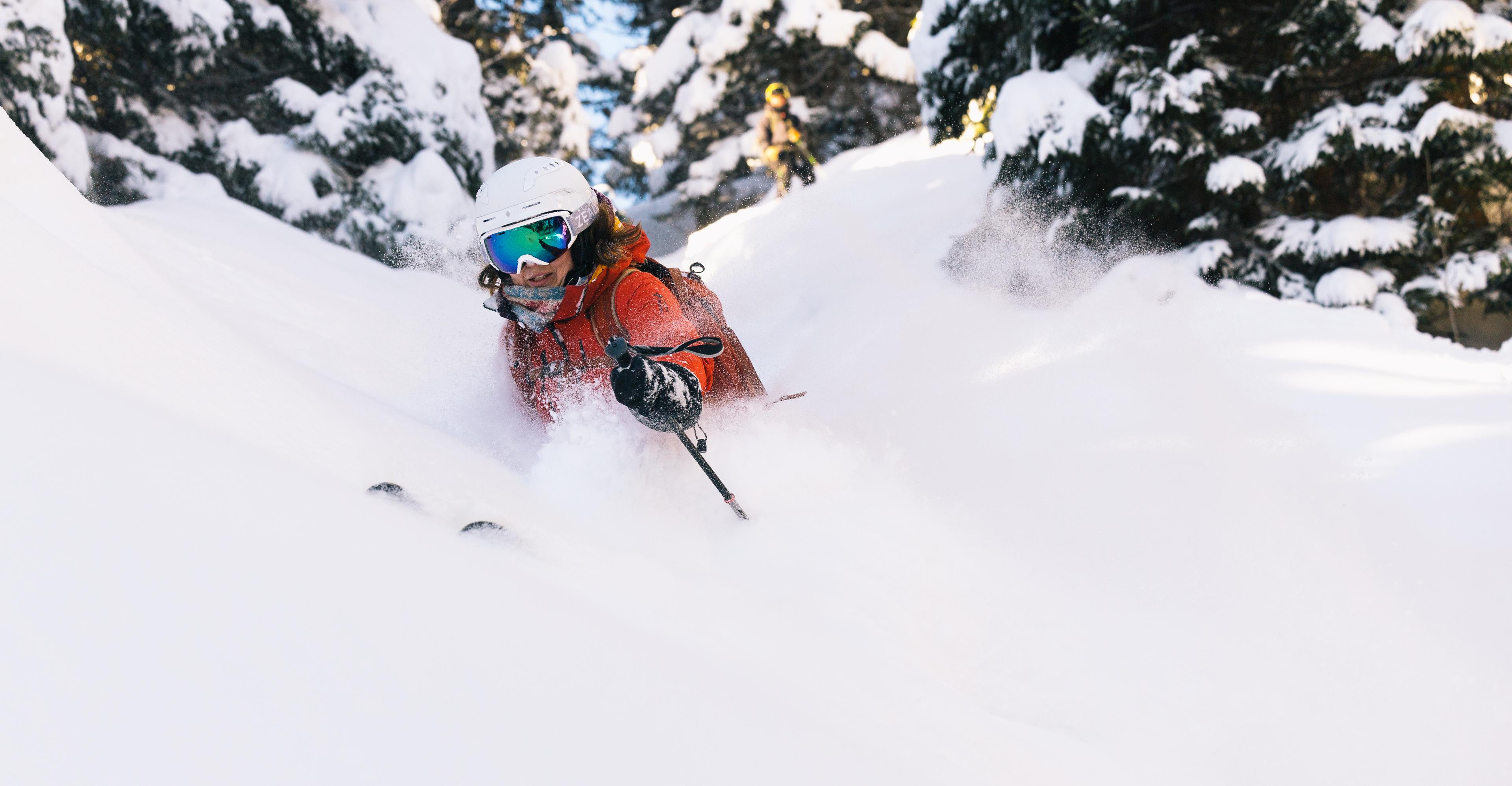 Frikjører i dyp snø gjennom skogen.