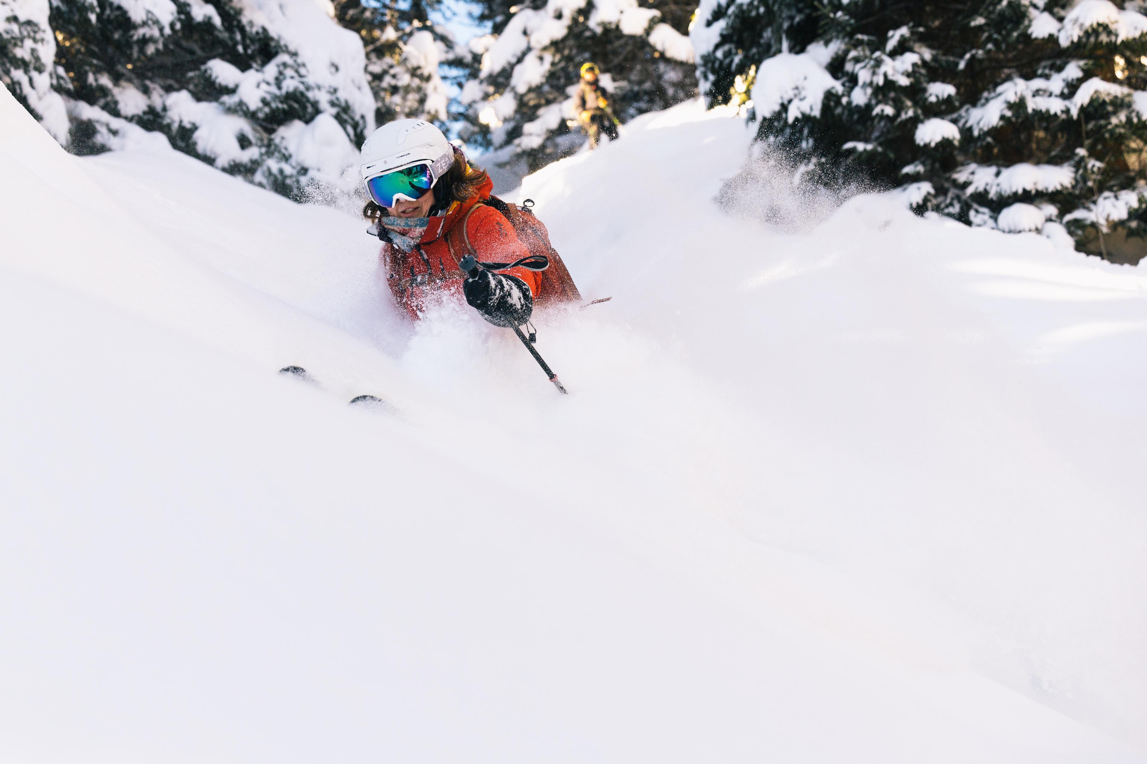 Skiing in deep snow through the forest.