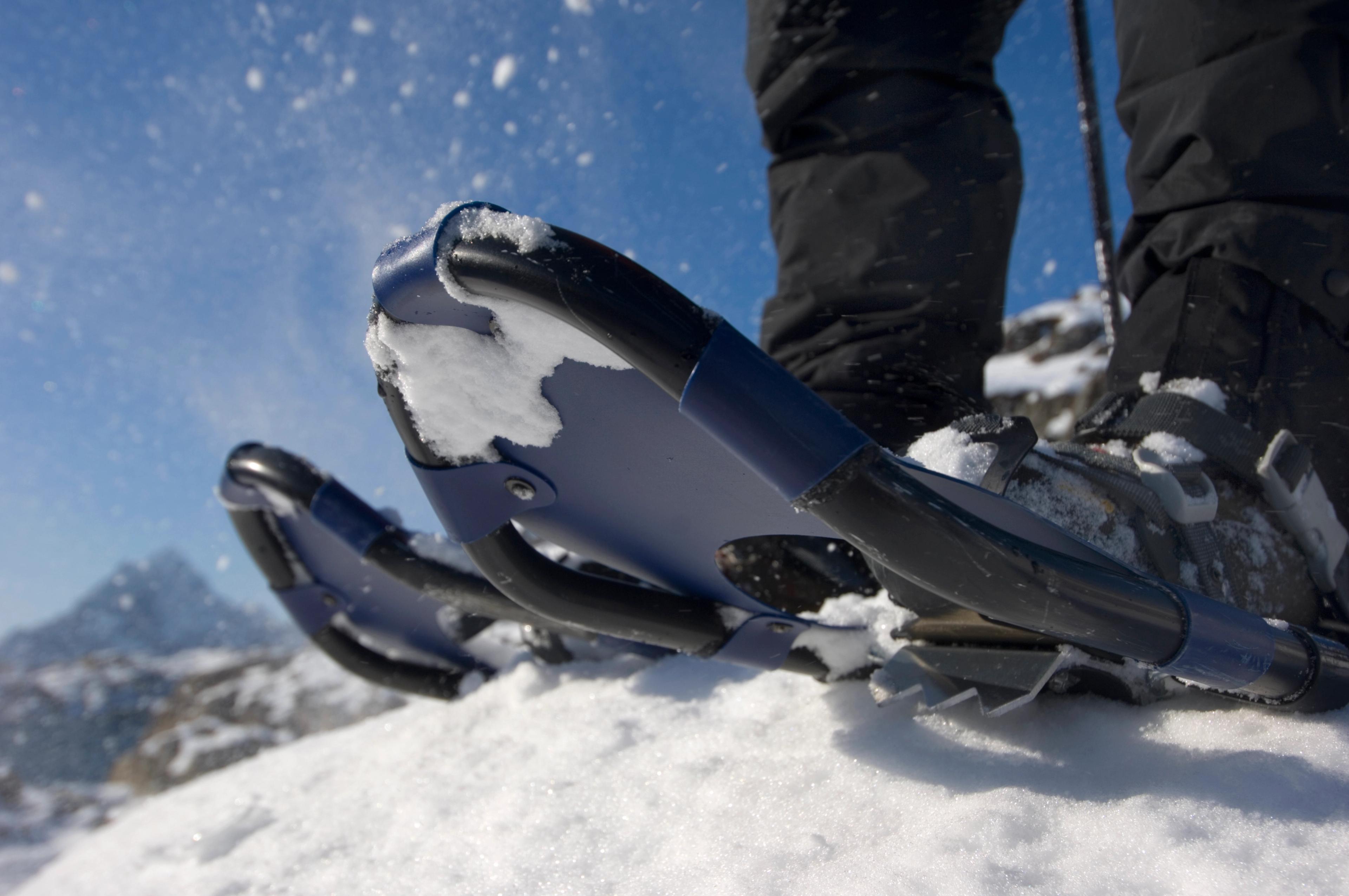 Close-up of snowshoes attached to a winter boot.