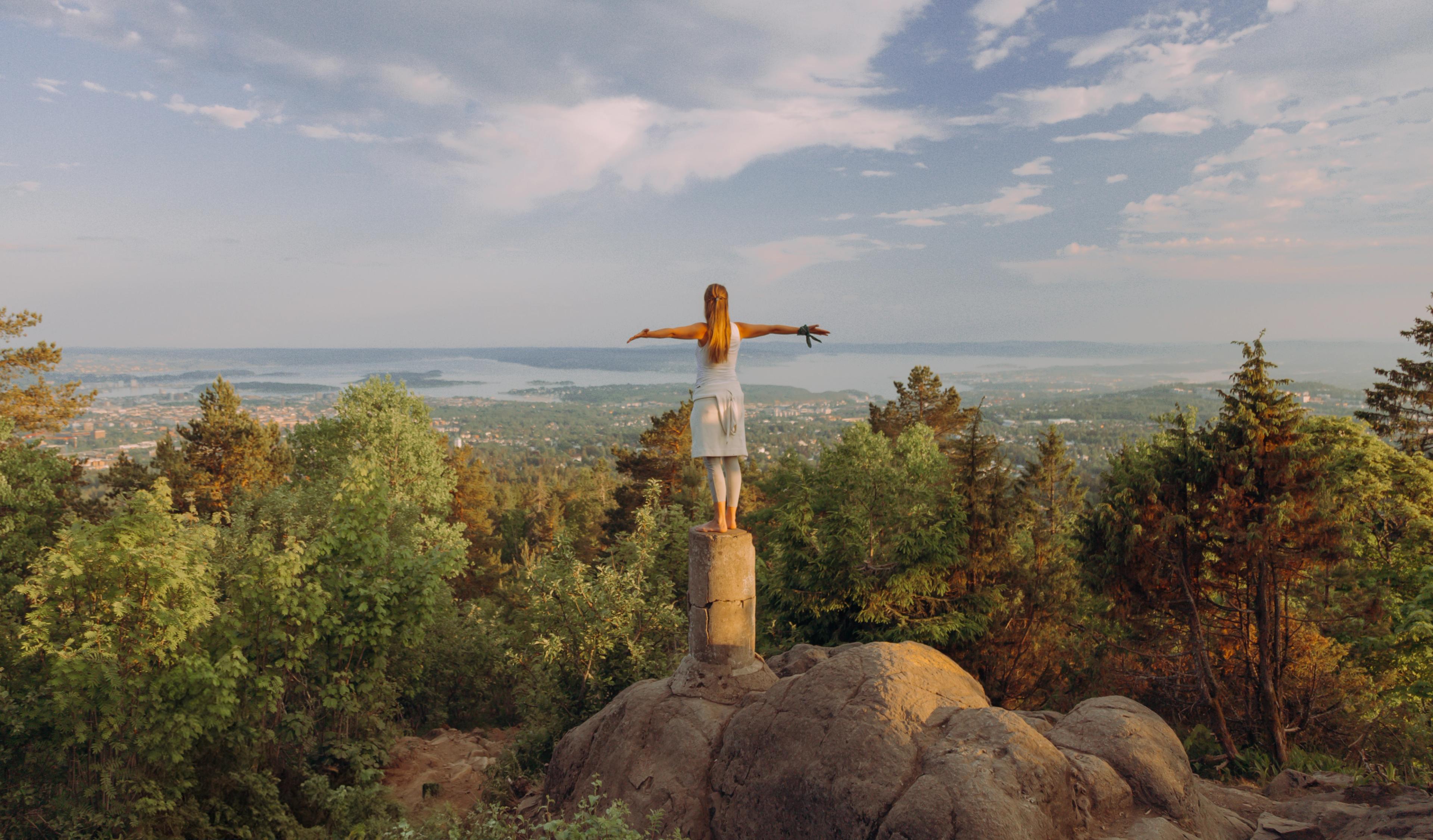 A woman enjoyng the view with her arms out to the side