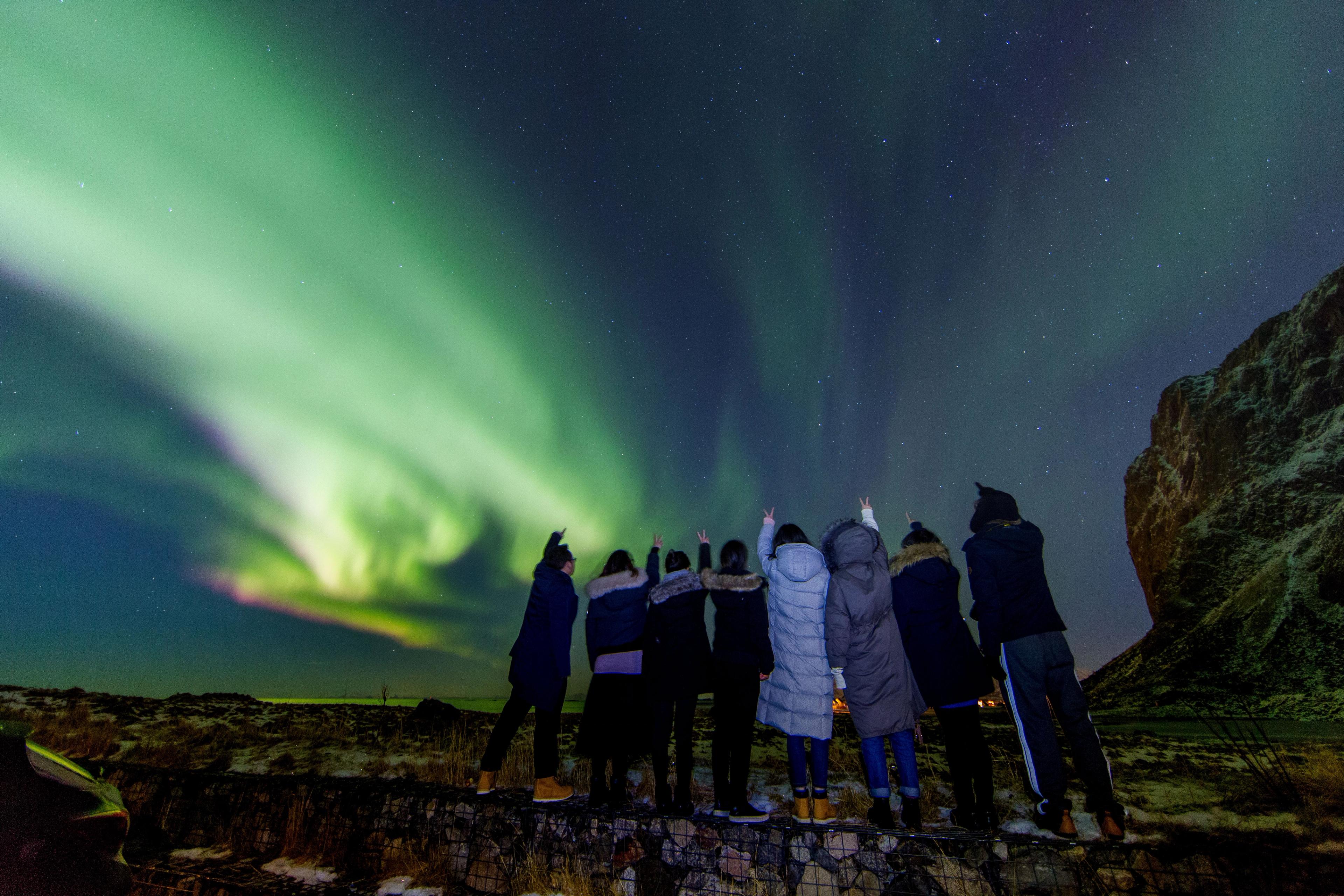 Eine Touristengruppe beobachtet die Nordlichter