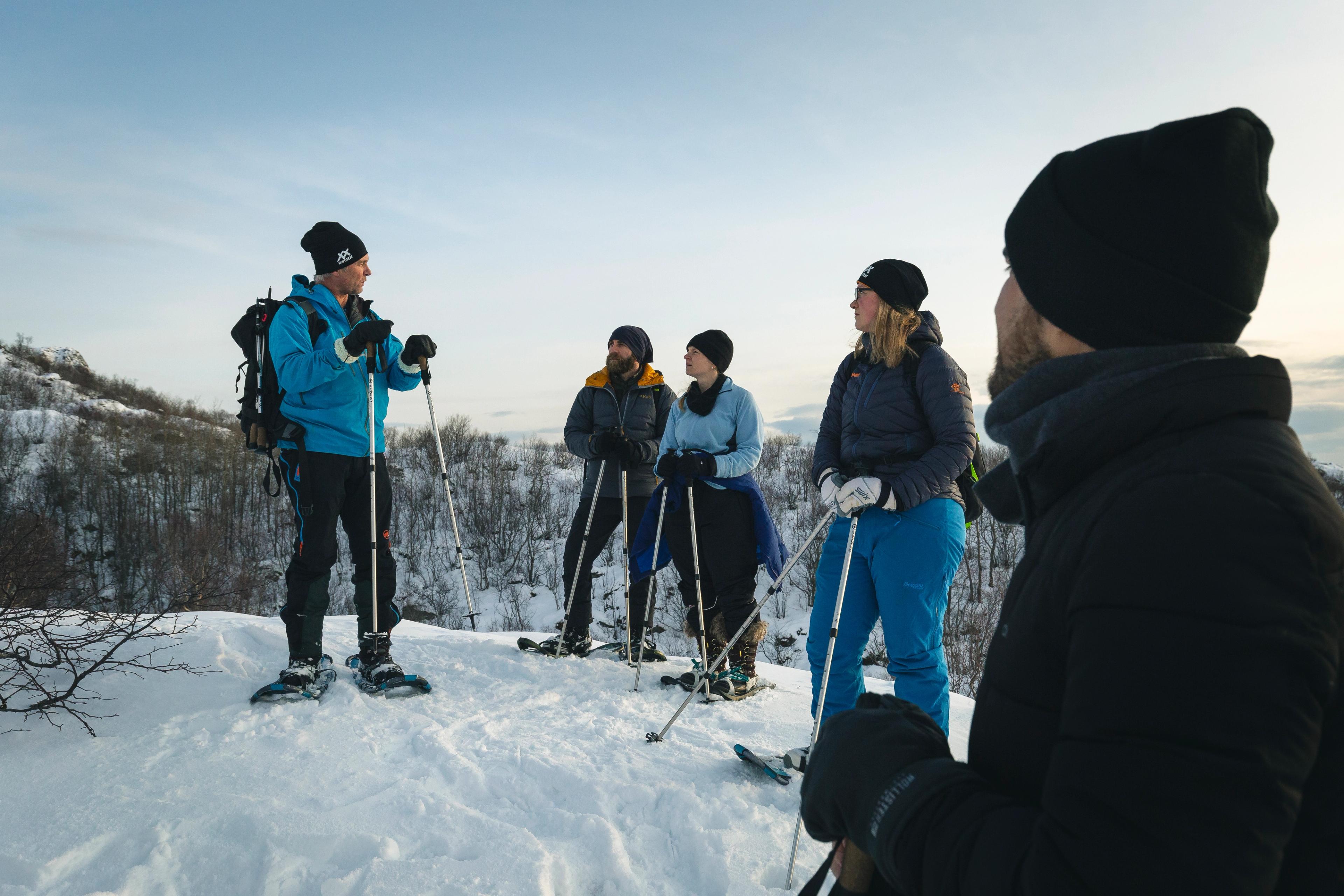 Visitors exploring the winter landscape with snowshoes and walking poles