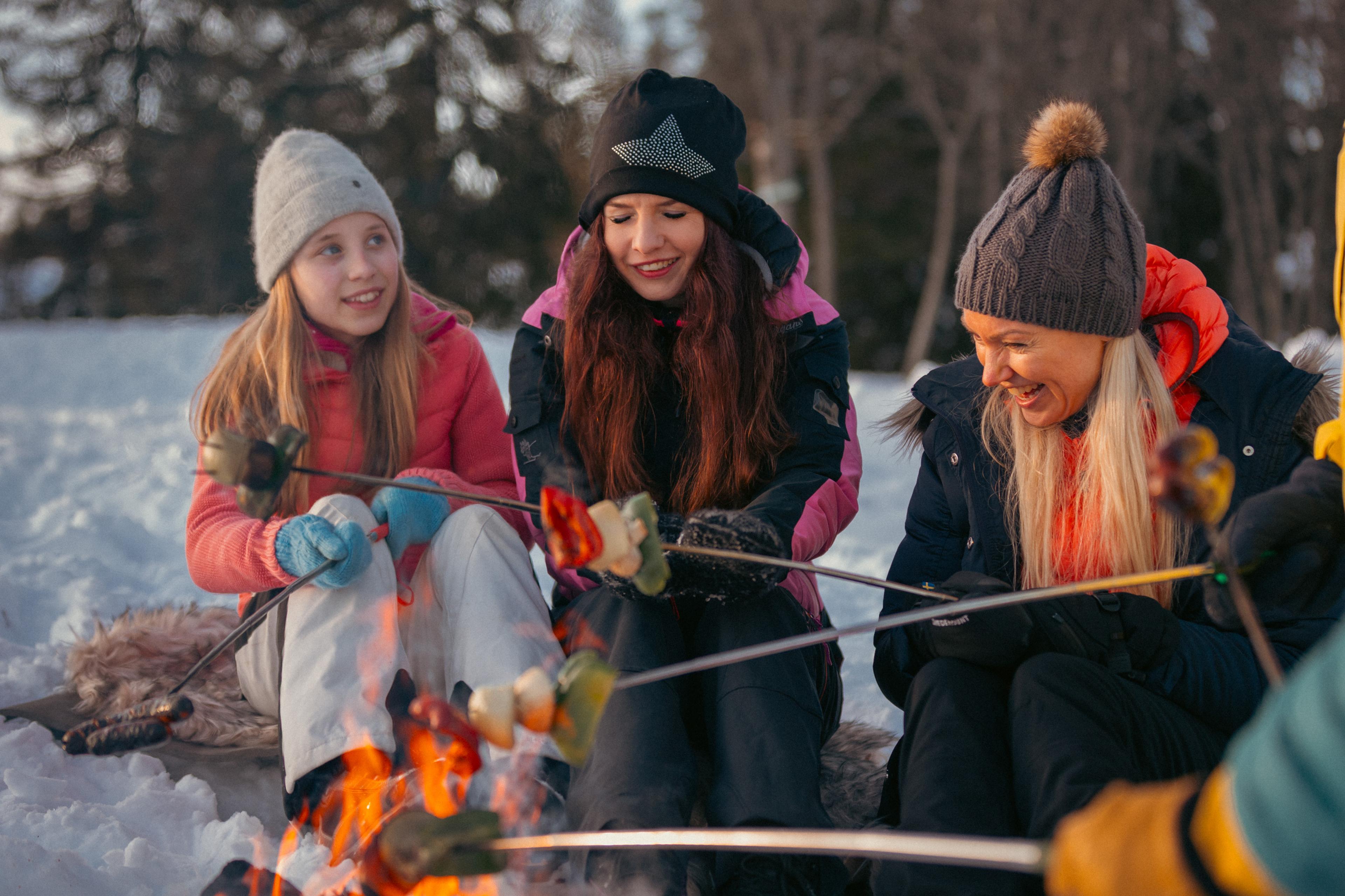 Three girls around the bonfire