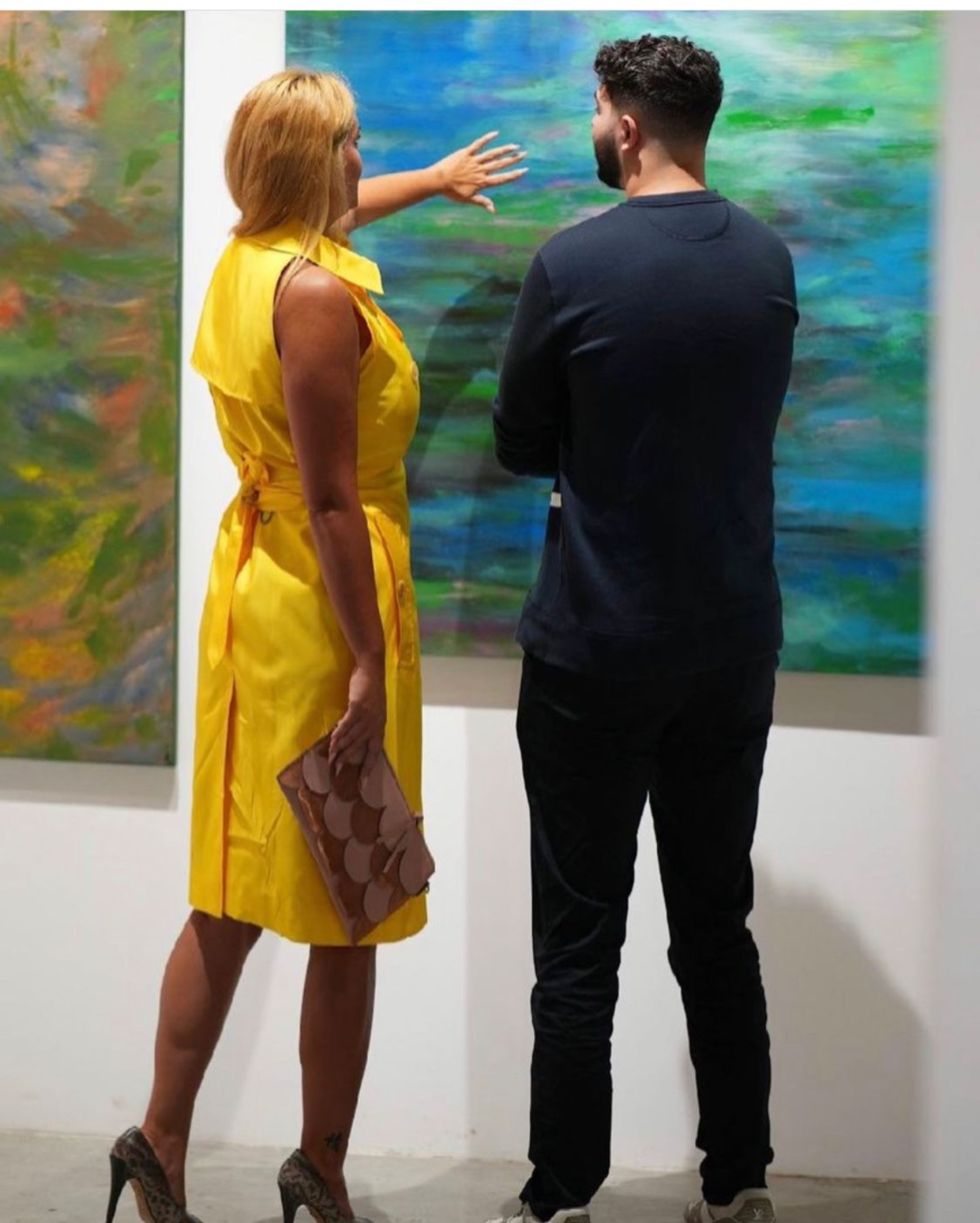 Rima Chahine talking about a painting at the opening of Nature, Bedia Gallery, Dubai