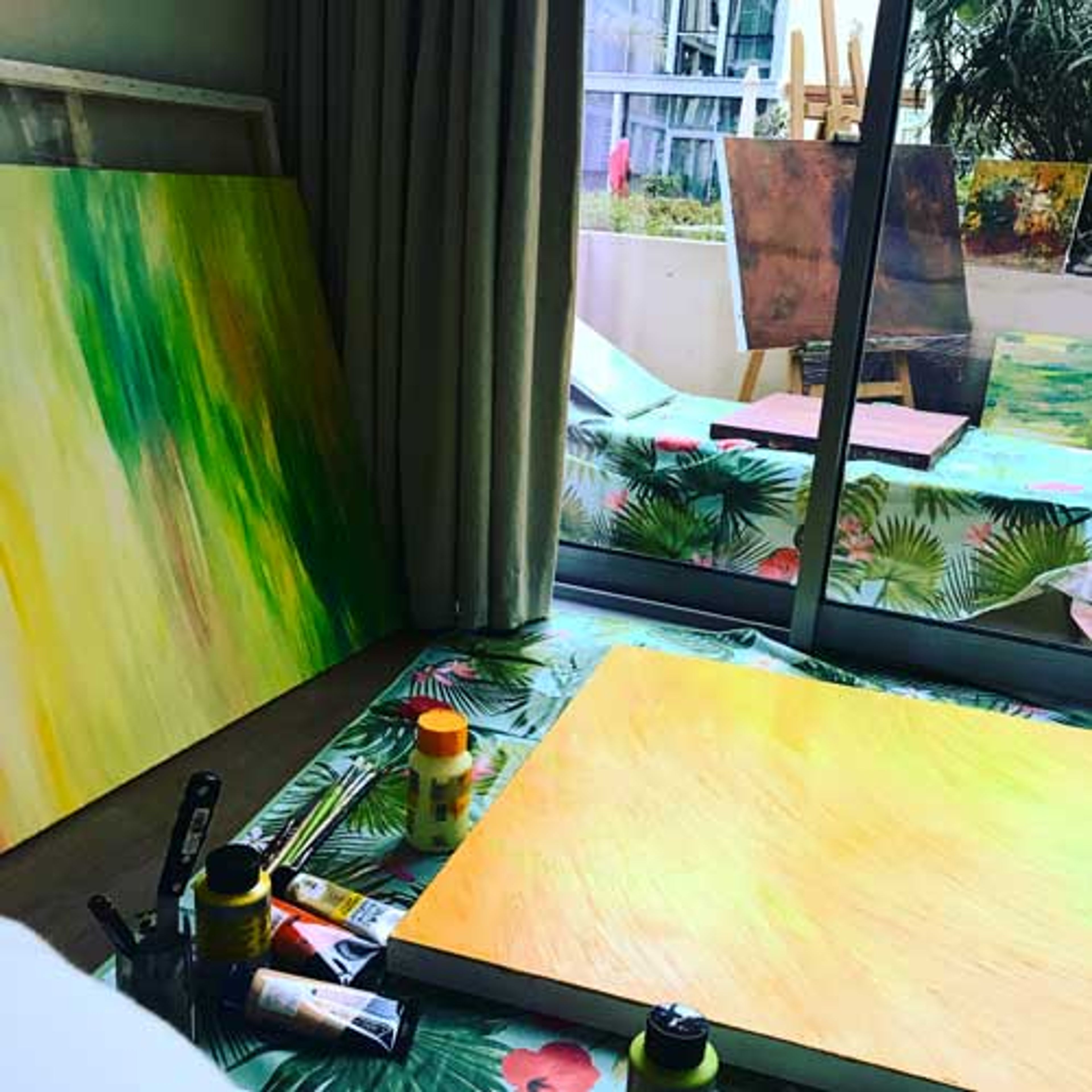 Canvases in progress and tubes of acrylic paint in Rima Chahine’s studio