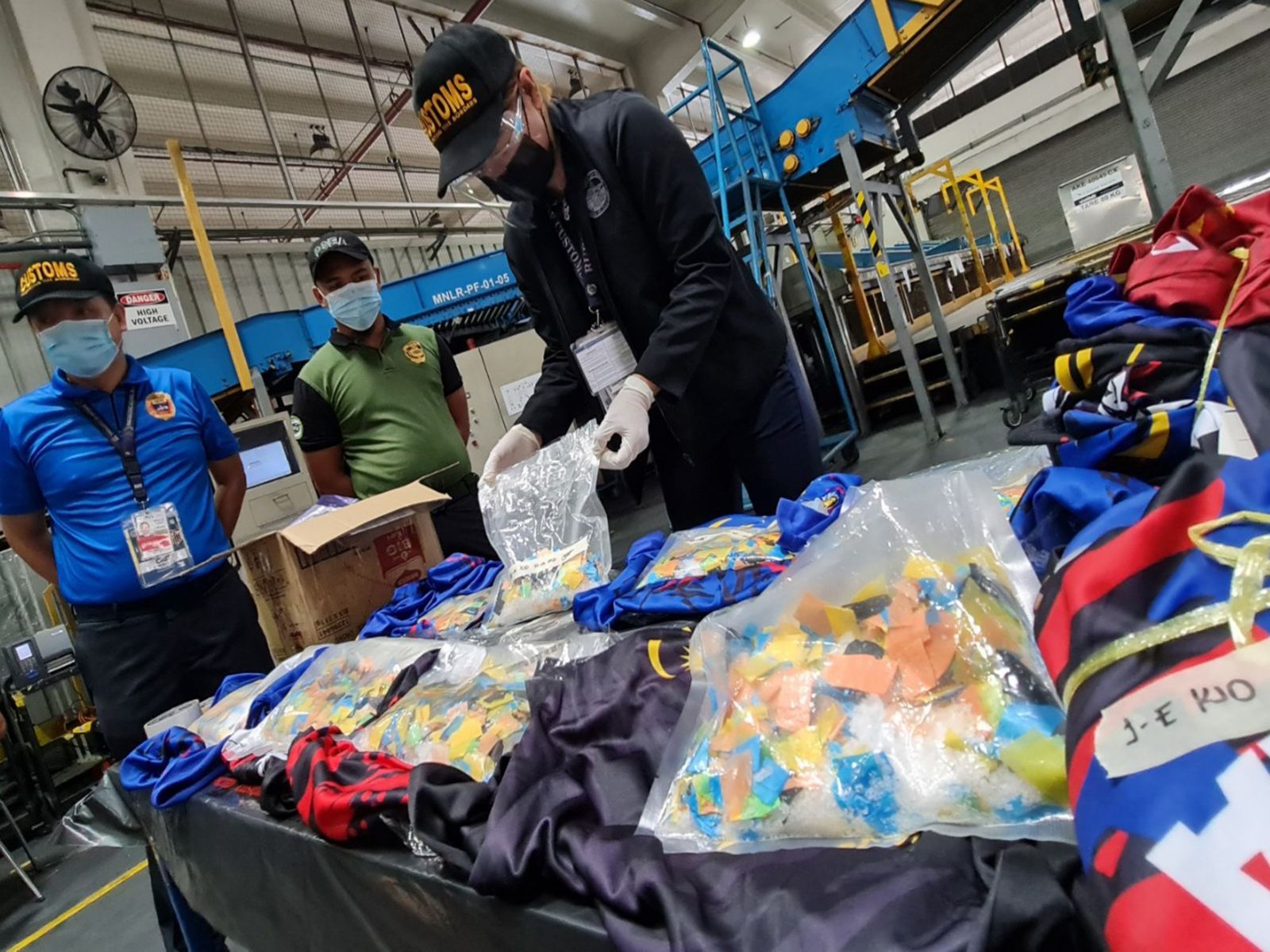 Government operatives  inspect the P15.64-M illegal drugs sent from Malaysia. (BoC-NAIA Photo)