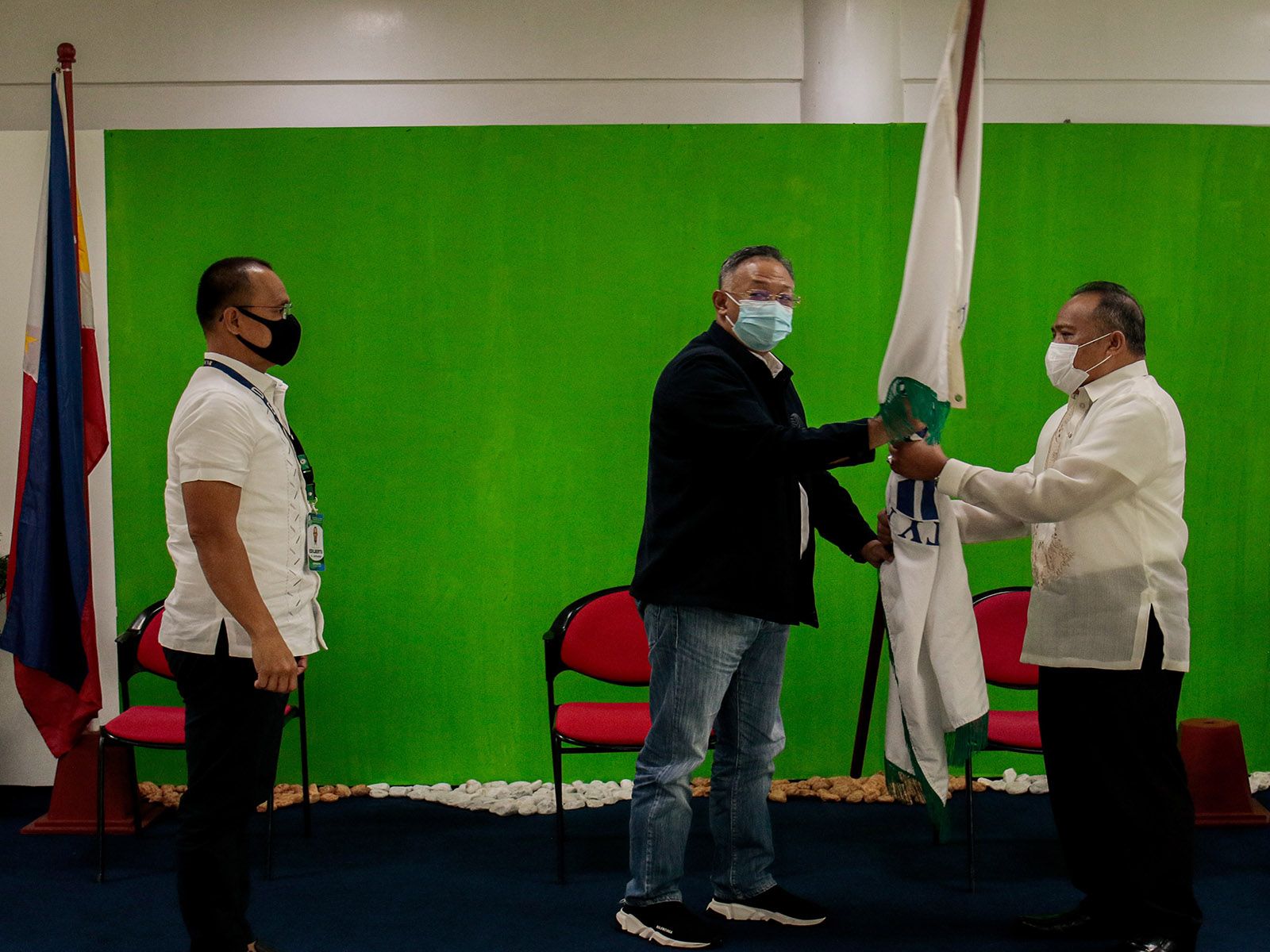 NEW BMB CHIEF. Incoming Department of Environment and Natural Resources - Biodiversity Management Bureau (BMB) Director Sultan Datu Tungko Saikol (right) receives the flag of the BMB from outgoing DENR-BMB chief Edilberto Leonardo (left), symbolizing his taking the helm of the office. SANTIAGO CELARIO