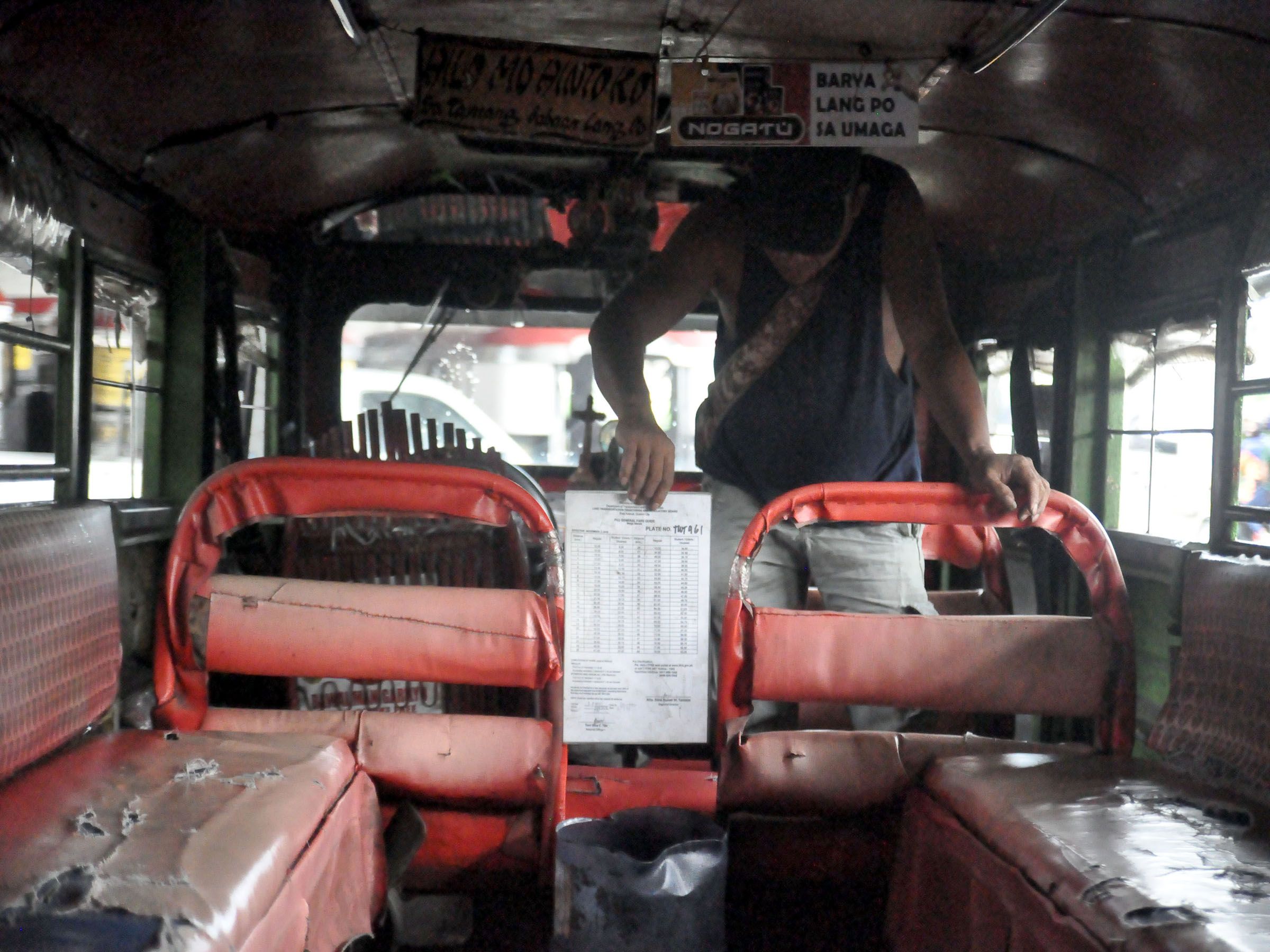 RETURNING OLD FARE MATRIX-- Since the Land Transportation Franchising and Regulatory Board ruled that new fare hike-- which is supposed to take effect today-- can only be imposed once the traditional and modern jeepneys have new fare matrix to be displayed, this driver returns his old fare matrix for the guidance of commuters.   DANNY QUERUBIN