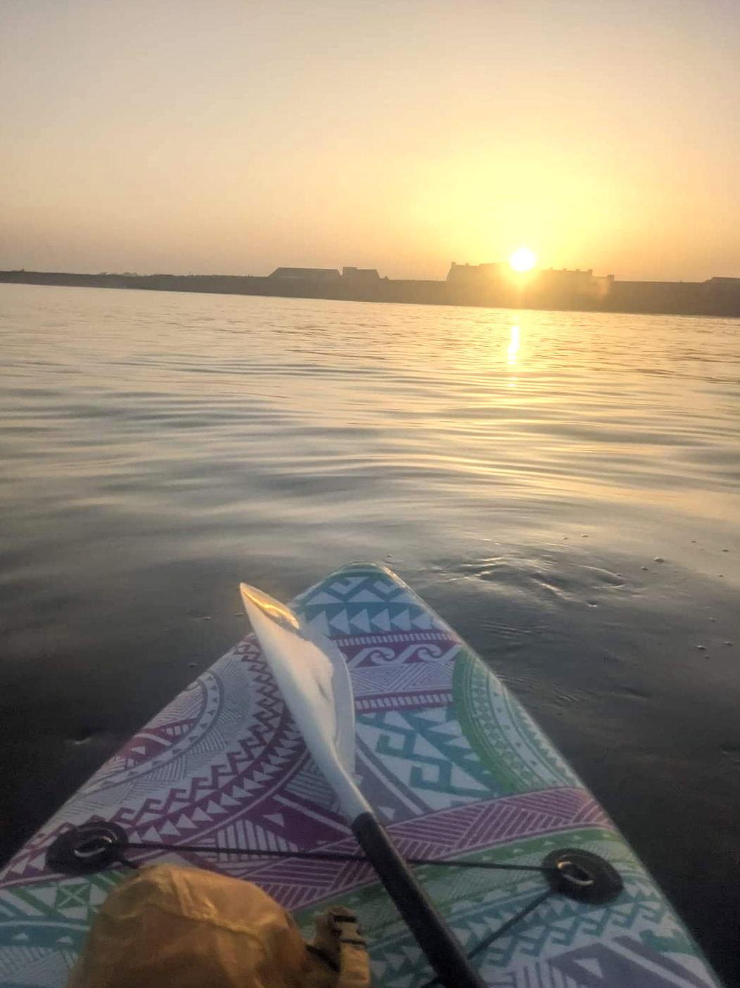 Nose of a paddleboard, enjoying the sunset over Carnoustie.