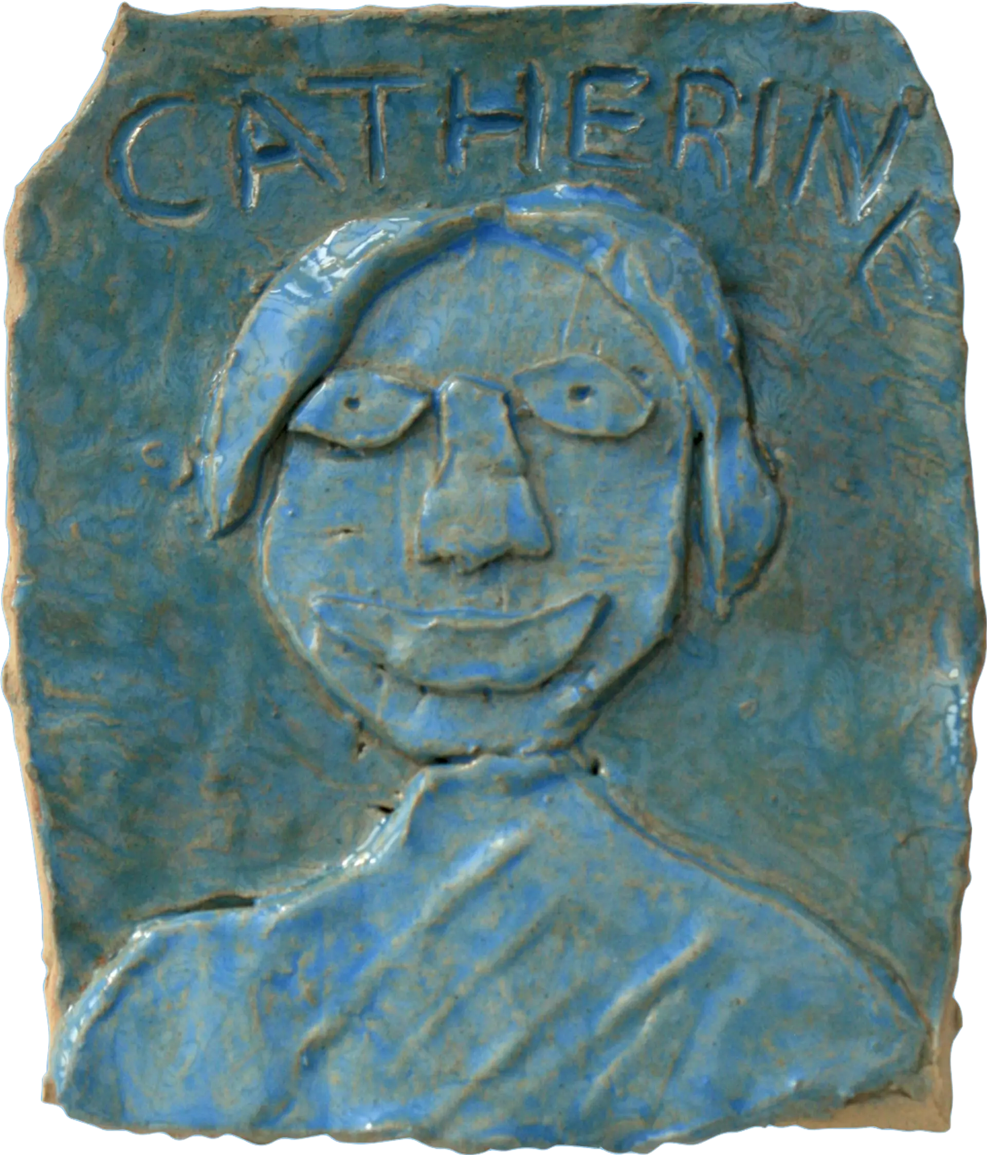 A blue glazed ceramic tile of Catherine, a mother of the group. She has short hair and is smiling.