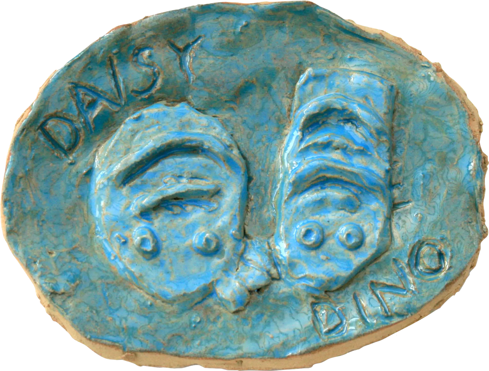 An oval shaped blue glazed ceramic tile of Lewis’s two guinea pigs, Daisy and Dino. Their names are written around the edge of the tile. They are sitting close together and have stripes along their bodies. 