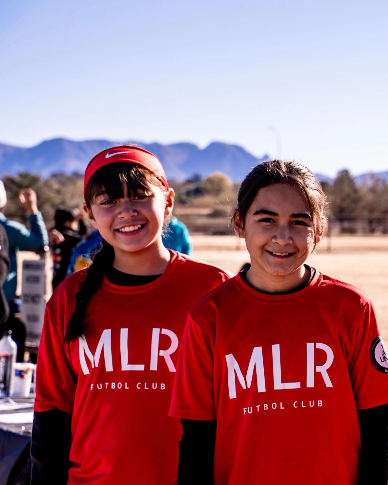 Five Girls U14 players lined up, the Organ Mountains behind them