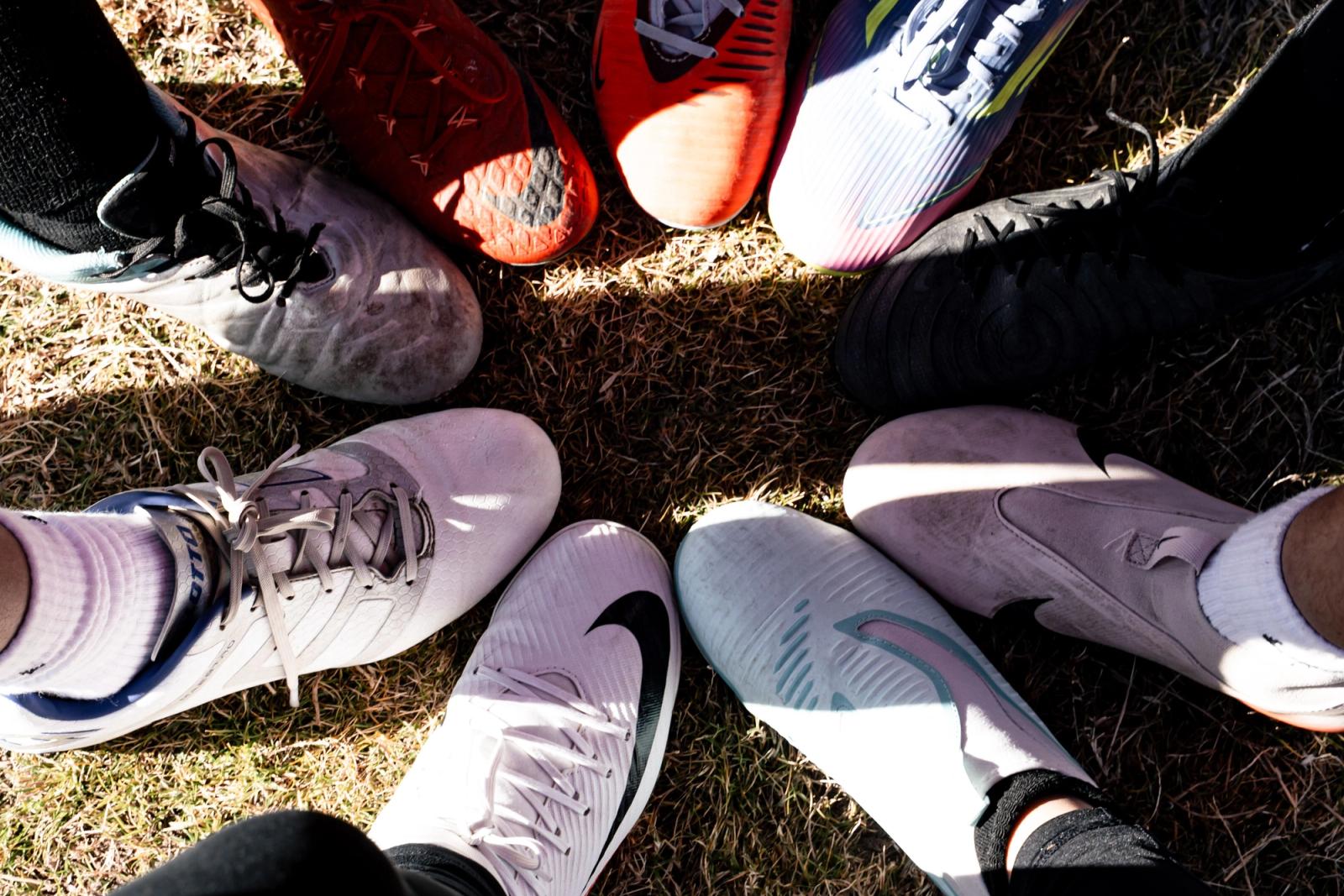 Cleats in a circle before kickoff