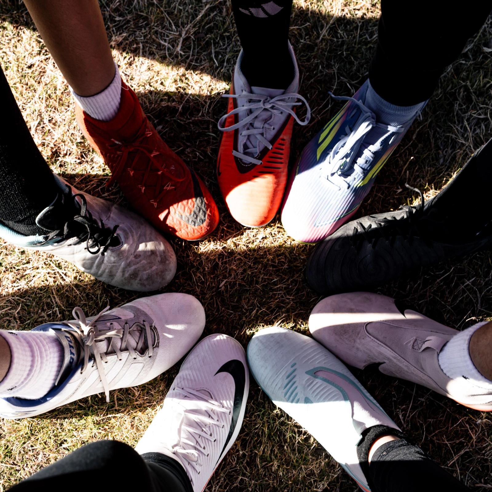 Cleats in a circle before kickoff