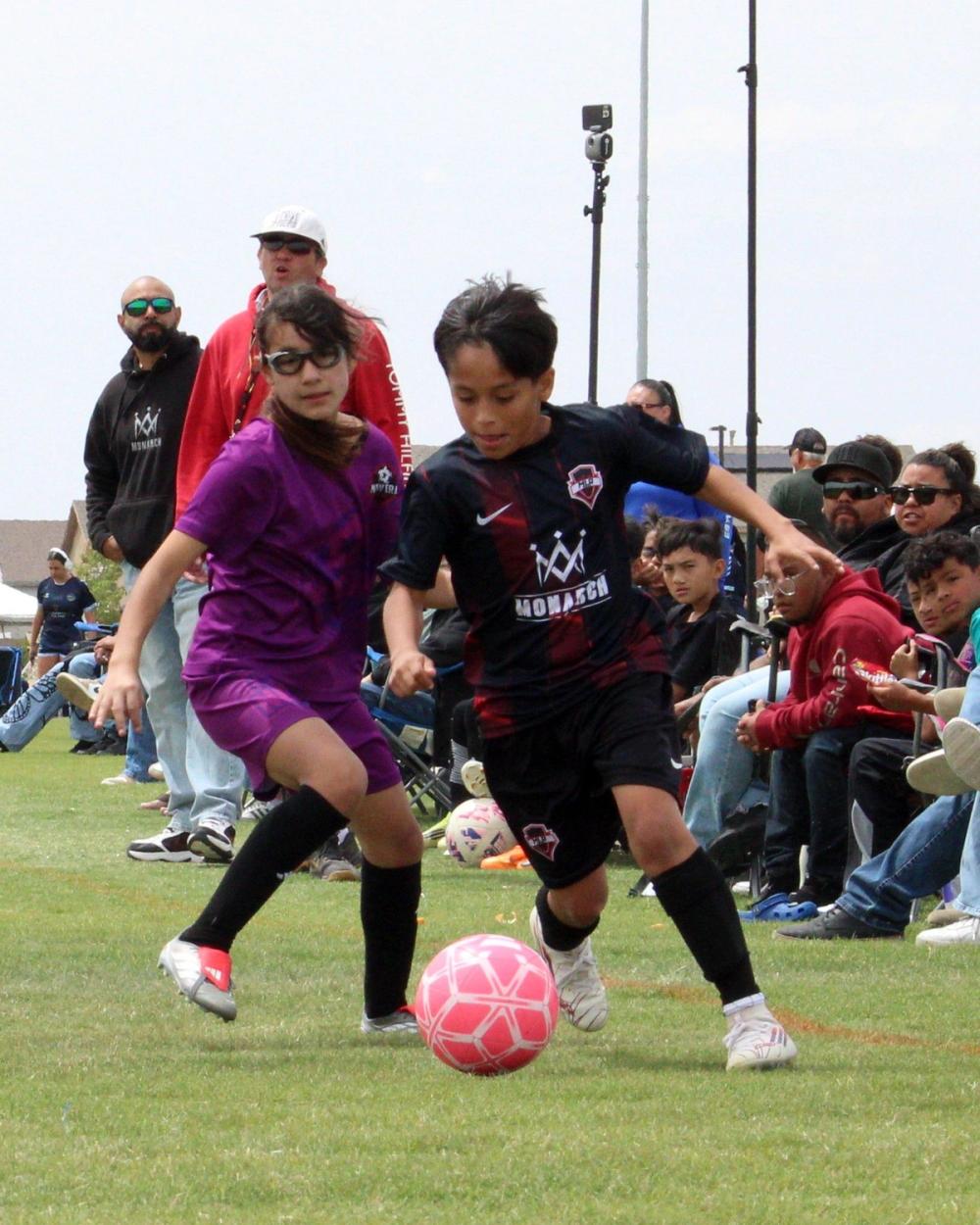 Boys player dribbling past a defender